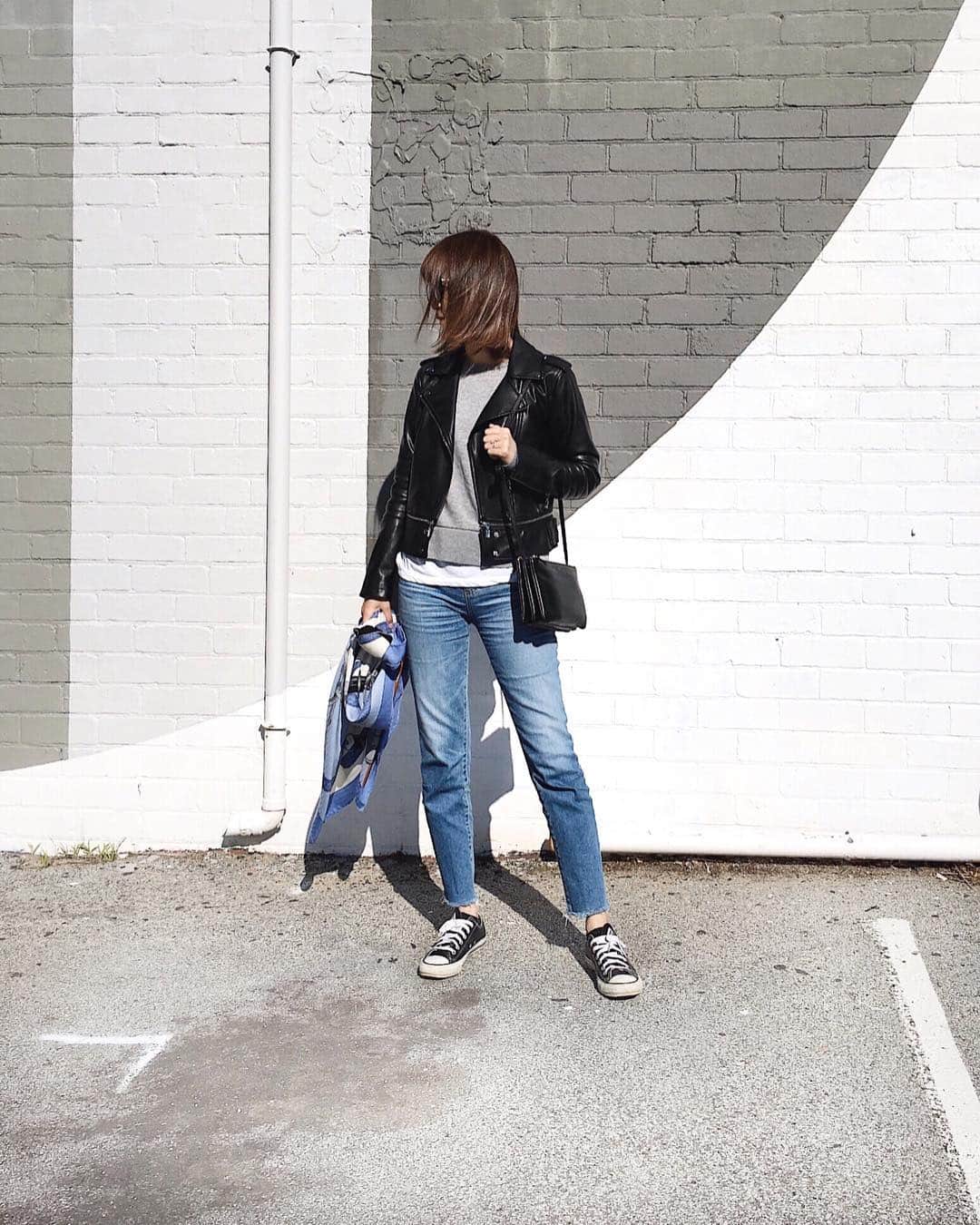 Shokoのインスタグラム：「Celine trio bag seems to be no longer the trend but I still love the simple and functional design so I always bring it when I travel. It's a great understated bag. I use it as a Pochette for hands free city touring. And then turn it into a clutch by detaching the front pouch for a fancy dinner night out. Will post it on my next pic. ・ セリーヌトリオはあまり流行っていないようですが、シンプルなデザインと機能性が好きなので旅行には必ず持って行きます。手ぶらで散策できるポシェットにしたり、ちょっと素敵な所に行くディナーには、前のポーチを取り外してクラッチがわりにしています。 ・ jacket #zara | Tshirt #jamesperse | jeans #agjeans in Isabelle 14 yrs destroyed | sneakers #converse | scarf #hermes  shawl in 140cm | bag #celine #celinetrio in small size」