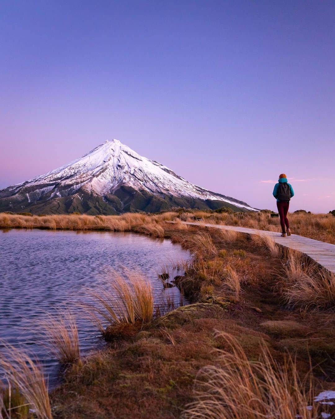 Travis Burkeのインスタグラム：「Check out last night’s views! It felt so great to hike in a National Park again!  After a two hour trek through a dense forest we reached the crest of this mountain greeted by crazy winds and below freezing temperatures. My hands were so numb I couldn’t even spin the filter off of my lens, but we explored the area a while, watched the last bit of sun glowing off the peak of the volcano, and tried not to slip on ice as we carefully made our way back down to sea level in the dark.  Winter is definitely setting in here in New Zealand and the heat waves that are happening back home in California look enticing, but @gypsealaysea and I think we’ll stay here and and keep exploring a little longer... How are things shaping up where you live?  #newzealand #sunset #frozenfingers」