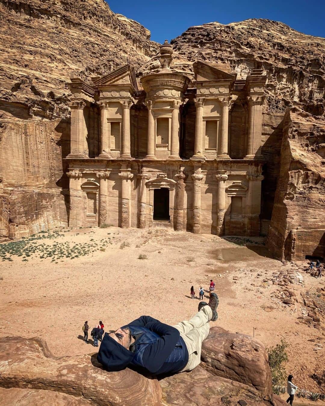 National Geographic Travelさんのインスタグラム写真 - (National Geographic TravelInstagram)「Photo by Muhammed Muheisen @mmuheisen | I made this self-portrait in February while taking a break after a very long hike to this majestic view of Ad Deir (Monastery), one of many facades carved into the mountains of the ancient city of Petra, Jordan. I’m always amazed by how small we appear in front of such historical sites.  For more photos and videos from different parts of the world, follow me @mmuheisen and @mmuheisenpublic. #muhammedmuheisen #Jordan #Petra #الاردن」4月17日 1時07分 - natgeotravel
