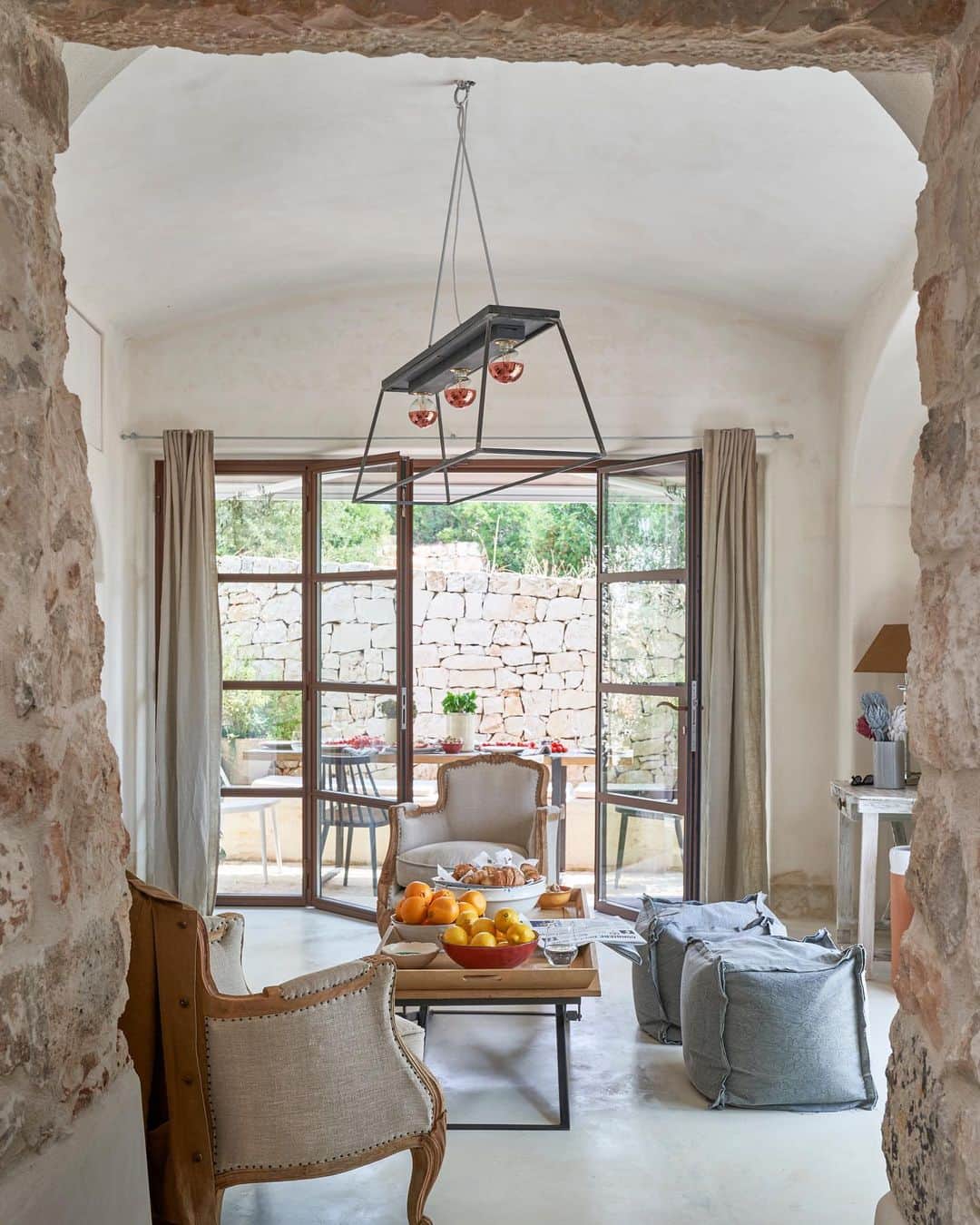 ELLE DECORさんのインスタグラム写真 - (ELLE DECORInstagram)「Bulgari's creative director, @lucia_silvestri, recruited architect and interior designer @bepi_povia_interiors to help with restoring her 17th-century home in Puglia. Povia installed a generous number of windows and sliding glass doors to create a sense of openness throughout the 900 square-foot space, with results that are truly striking.  The living room pictures poufs from @maisonsdumonde and polished, cement floors. Click the link in bio for the full house tour, as featured in our May 2020 issue. Produced by @whowhatwhit. Photography by James Merrell.」4月17日 7時02分 - elledecor