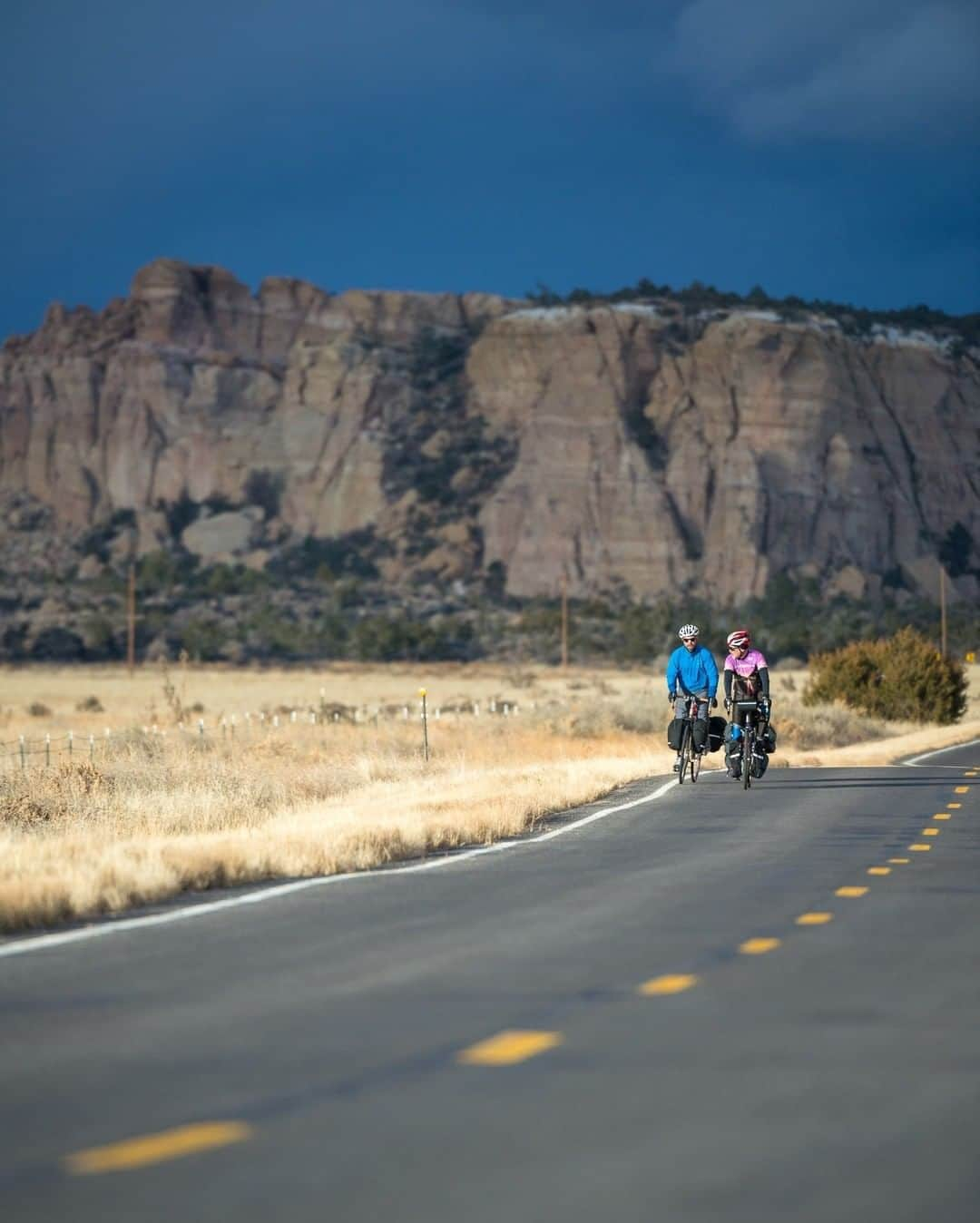 National Geographic Travelさんのインスタグラム写真 - (National Geographic TravelInstagram)「Photo by @michaelclarkphoto | Patrick O'Grady and Owen Haggard bike near Grants, New Mexico. Bicycle touring is one of my favorite ways to travel. It slows you down perfectly to see the countryside and experience the towns, villages, and people. The idea to go for it as a photographer and launch my career was dreamt up while on a bike tour in the south of France about 25 years ago. Once this virus is over, it might be time to do another bike tour in my own country. #biketouring #adventurecycling #newmexico」4月28日 17時08分 - natgeotravel