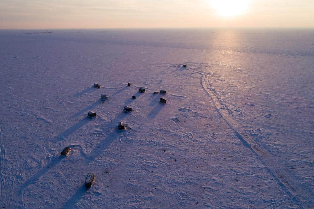 National Geographic Travelさんのインスタグラム写真 - (National Geographic TravelInstagram)「Ice houses dot northern Minnesota once the lakes freeze over, creating entirely new landscapes. Fishermen tow these tiny houses onto the frozen water to spend their days, nights, and even weekends sleeping out on the ice living as a temporary community sharing their love of the land. Photograph by @ErikaSkogg and @ScandinavianAmerican」1月11日 1時04分 - natgeotravel