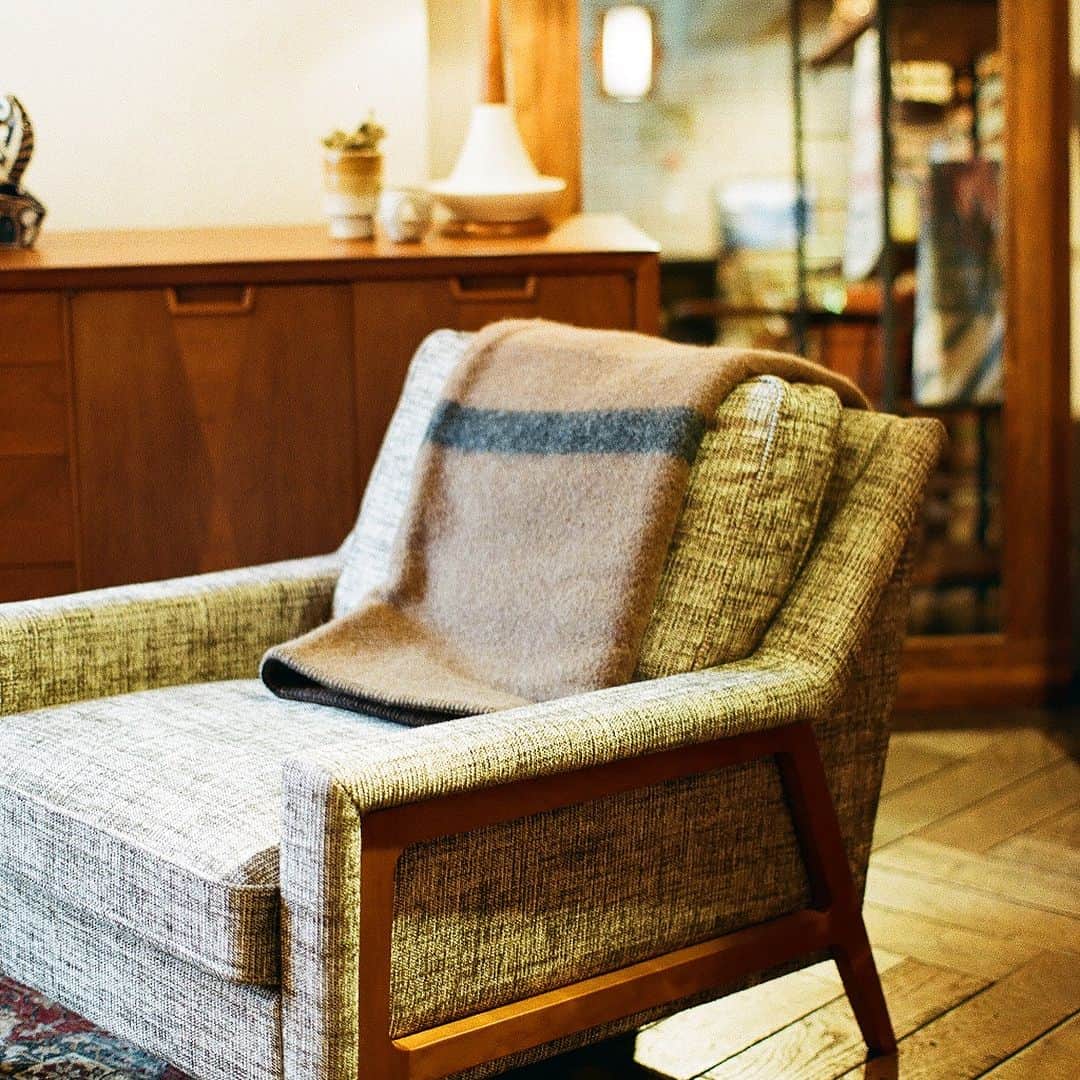 ACME Furnitureさんのインスタグラム写真 - (ACME FurnitureInstagram)「・ 幡ヶ谷 PADDLERS COFFEEが一から製作したオリジナルのブランケット《Armchair Blanket》がACME Furniture目黒店、大阪店にて明日1月12日より販売が開始致します！ ・ 上質なセーターなどに使われる、イギリスの北方に位置するシェットランド諸島の羊毛、"シェットランドウール" を使用した超厚手のブランケット。シェットランド諸島の厳しい冬の寒さや湿度の高い天候、それに海草を副食に採るなどの飼育環境によって、柔らかい毛質をもつのが特徴。 ・ 愛知県一宮市に工場を構え天然素材の良さを追求した織物を製造する機屋、【T'acca（タッカ）】さんにより、《ArmchairBlanket》が完成致しました。触れたときの "ふわっ" とした生地感や厚みや暖かさ、カラーリング、サイズ感、ラベルデザインなどとことん拘り、セットになるブランケットがぴったり入る円柱型のオリジナルバッグの製作は、D.I.Yレーベル『41世紀』倉橋氏。ガシガシ使えるよう、生地には厚手の国産6号帆布を使用。2色のブランケットのカラーに合わせスティッチのカラーも2色展開。 ・ そして《Armchair Blanket》のために製作したオリジナルの2種類の織ネームのデザインは、『COMFORTABLE REASON』のデザイナーの百武氏によるものです。 ・ ※サイズは【縦100cm × 横150cm】。 2つに折って膝掛けに、そのままマントの様に身体を覆うのに使うのにもちょうど良いサイズ感です。 ※カラーは【Brown × Dark Grey】と【Light Grey × Oregon Green】の2カラー。 ブラウンはコーヒー、ライトグレーに入るフォレストグリーンはオレゴン大学のキャンパスカラーをイメージ。  PRICE:￥22,000-（tax in） ・ ・ #armchairblanket #paddlerscoffee #タッカ #41世紀 #comfortablereason #acmefurniture #acmemeguro #acmefurnitureosaka」1月11日 16時03分 - acme_furniture
