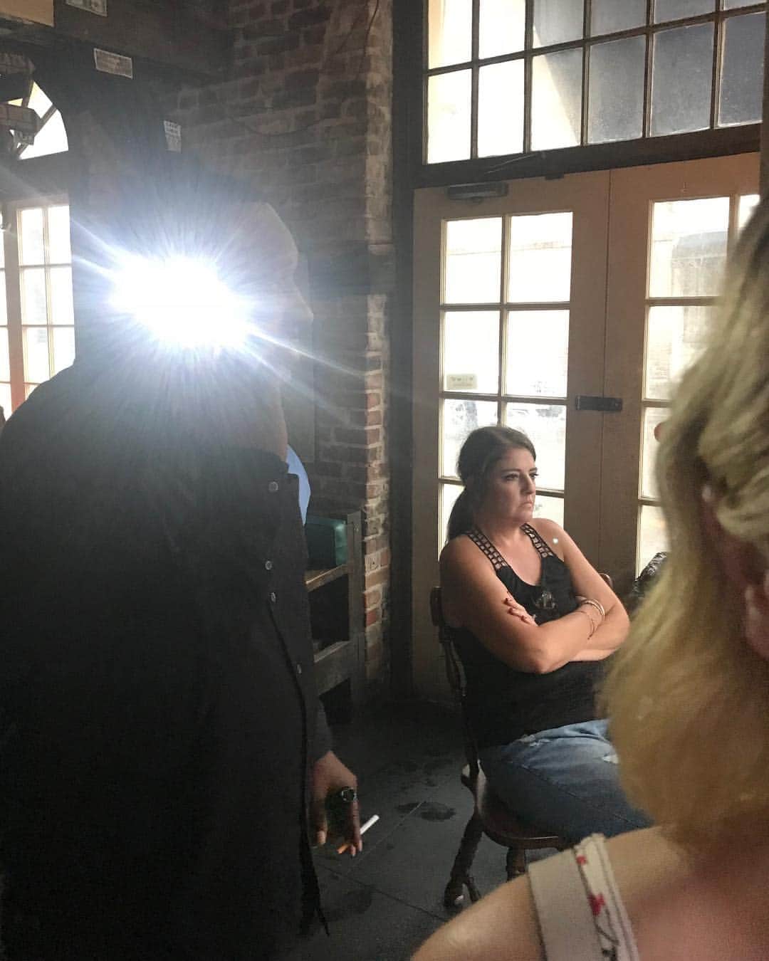 のインスタグラム：「An advanced technique betrayed by an amateur mistake. There are times when you feel like the antagonist and times when you feel like a character in the background. And while I’m sure I could sit here and write to you of the bubbling fury I felt deep in my man womb, how much easier it is to simply liken my emotional state to the woman behind our fair human heatlamp: the fog of war stare, arms folded in resignation. I’m actually impressed with the phone call technique, nothing new to me -a cynical master of the paranoid arts, but nonetheless advanced. A shame the tact was shattered by an automatic flash feature, burning deep into my soulless eyes the image of a fallen man on the precipice of the void we call ~social media currency~ #ad #cameraduels」