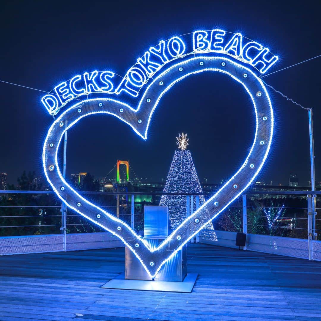 デックス東京ビーチ公式Instagramのインスタグラム：「🎄メリークリスマス🎄🎅🏻 . デックスは東京湾の夜景を背景に輝くイルミネーションで大盛り上がりです🌟 . 特に「ハート型オブジェ」は巨大イルミツリーとレインボーブリッジを一度に撮影ができ、記念撮影スポットとして人気です💓(1枚目) ハートの中央のボタンを押すと、美しいメロディーが響き渡ります♪ . お台場の夜景を一望できるレストランやカフェもございますので、ご家族や大切な人とゆったり幸せな時間をお過ごしくださいね🎁✨ . シーサイドデッキには、レゴ®で出来たオブジェも…！(2枚目) . デックスのレゴランド®・ディスカバリー・センター東京では12月30日まで「レゴ®クリスマス こどもマーケット」開催中です🔔 . #お台場 #デックス東京ビーチ #デックス #japan #tokyo #odaiba #deckstokyobeach #decks #お買い物 #ショッピング #ショッピングモール #お台場デート #クリスマス #クリスマスツリー #お台場海浜公園 #写真撮影 #クリスマスイベント #夜景 #お台場夜景 #YAKEI #夜景好き #イルミネーション #レインボーブリッジ #クリスマスイルミネーション #クリスマス🎄 #東京夜景 #メリークリスマス #legoland #レゴランドお台場 #レゴランド」