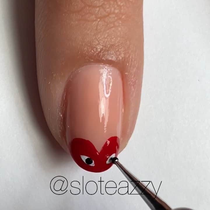 Yasmeenのインスタグラム：「Quick simple V-day mani ❤️ I used @dermelect A Shore Thing for the base color, Red-iculous for the heart, white and black acrylic paint for the eyes , all topped with Expedite again by @dermelect ❤️ SONG 🎶 Love Galore by SZA (feat. Travis Scott)  #nailsbysloteazzy」