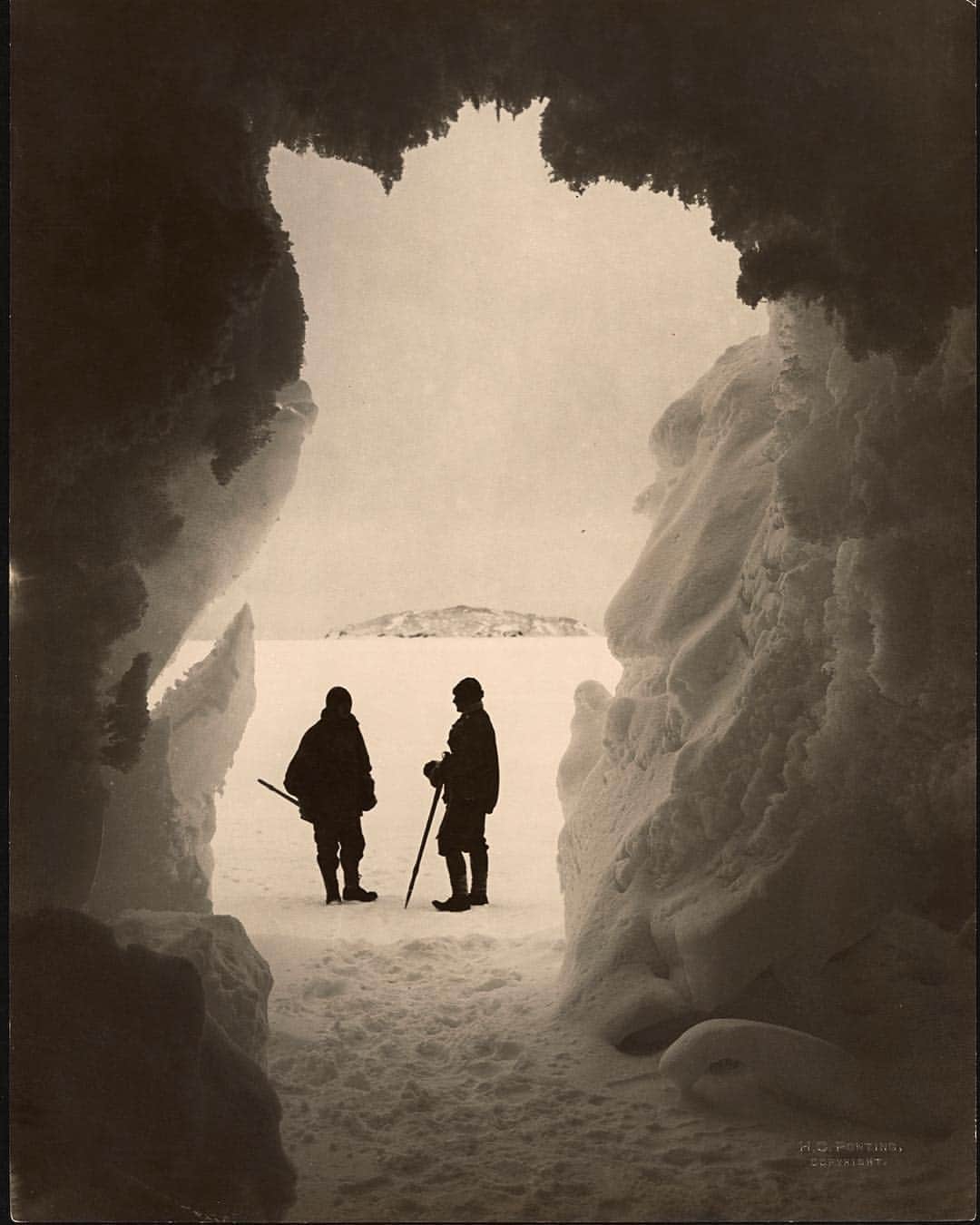 のインスタグラム：「Photo by Herbert G. Ponting | Two explorers stand outside a cavern by Erebus glacier, Antarctica. #ThrowBackThursday #Exploration #Antarctica」