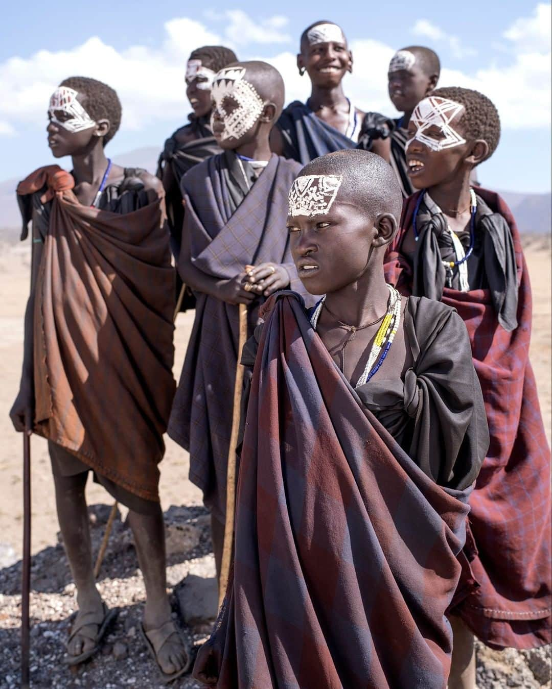 National Geographic Travelさんのインスタグラム写真 - (National Geographic TravelInstagram)「Photo by @gabrielegalimbertiphoto | Tanzania, somewhere between Ngorongoro and Serengeti - A group of teenage Maasai newly circumcised. The Maasai of Tanzania and Kenya have a series of rites of passage that accompany boys into adulthood. Every 10 or 15 years a new warrior class will be initiated into the tribe. Boys between the ages of 10 and 20 are brought together from all across the country. Dozens of houses are built that will serve as the place of initiation. The night before the ceremony, the boys sleep outside in the forest. At dawn, they return to the little makeshift homestead for a day of singing and dancing. They drink a mixture of milk, cow’s blood, and alcohol and eat piles and piles of meat. After the festivities, boys who are of age (12-16) are ready to be circumcised. The Emuratare is the most important ceremony in the life of a Maasai boy. Once circumcised, the tribe will consider him a man, warrior, and protector of his village. As the young man makes his way to where the elders will circumcise him, friends and family members will taunt the boy by saying things like “If you flinch, we will disown you.” The Maasai value bravery of their warriors and the circumcision is a boy’s first way to prove his courage in the face of severe pain. It takes about 3 months for the circumcision to heal and during that time the young men wear black clothing and live in huts built by the women of the village. The Maasai boy is now warrior. #maasai #tanzania #child」4月5日 13時01分 - natgeotravel