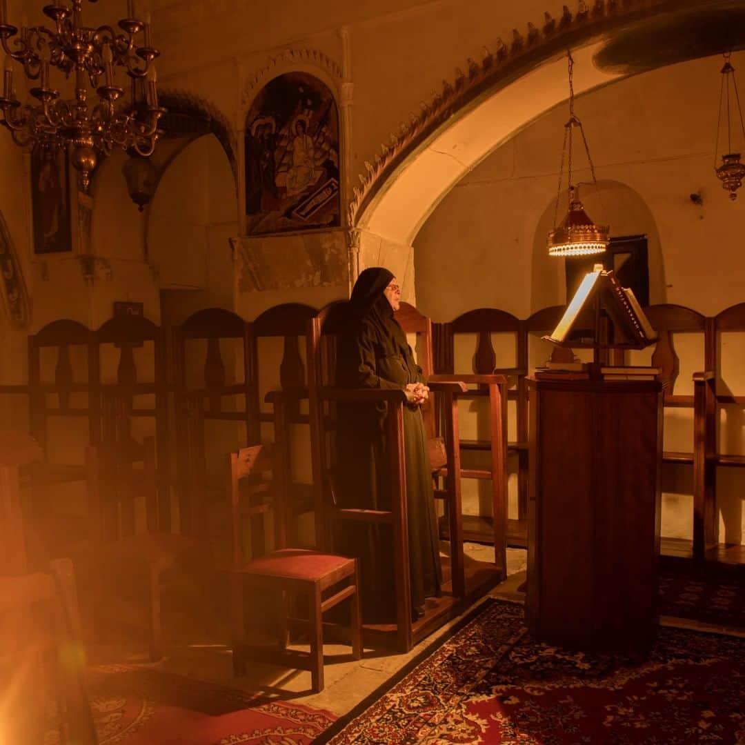 National Geographic Travelさんのインスタグラム写真 - (National Geographic TravelInstagram)「Photo by @chiaragoia | Sister Irini prays inside the church of St. George Valsamitis monastery in the early morning. Sister Irini is a Greek Orthodox nun who came to Amorgos for the first time 35 years ago as a tourist with her children and her husband. She fell in love with the island and she returned here as a nun 7 years ago when she took over an abandoned monastery and restored it herself. She spends her days gardening, painting, and praying, but always welcomes visitors to her monastery. Her routine is quite dense, with days starting at 4.30 am. #greece #amorgos」4月5日 22時02分 - natgeotravel