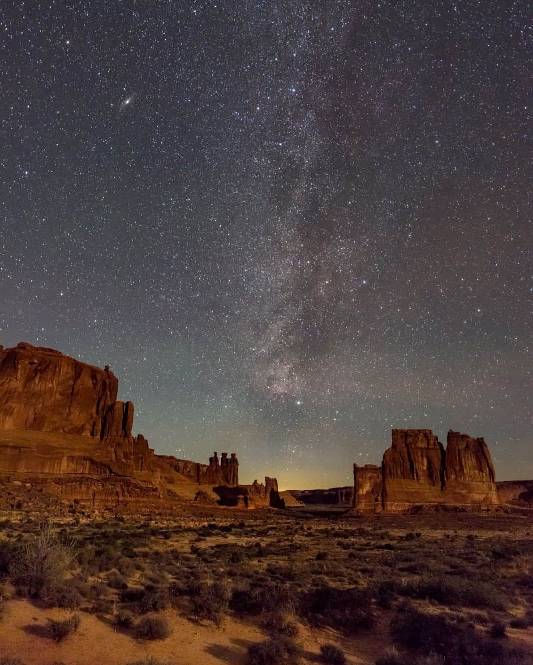 ナショナルジオグラフィックさんのインスタグラム写真 - (ナショナルジオグラフィックInstagram)「Photo by @babaktafreshi | Desert Solitaire. I was not familiar with this iconic autobiography by Edward Abbey (1968) until a visit to Utah’s Arches National Park, where desert becomes a rock wonderland, where the stars touch the Earth. This photograph is a tribute to Abbey, who wrote about his experiences as a park ranger here in late 1950s in "A Season in the Wilderness." He later became a voice for environmental issues and public land. Here, the Milky Way from Cygnus (bottom) to Cassiopeia appears in the sky. A gentle moonlight illuminates the ground. The North America Nebula is faintly visible near the center, next to bright star Deneb. Andromeda Galaxy, the Milky Way’s grand neighbor, is on the upper left, easily visible to the naked eye in a sky like this. Follow @babaktafreshi to explore the world at night. #nationalparks #nightsky #desertsolitaire #edwardabbey」4月6日 10時05分 - natgeo