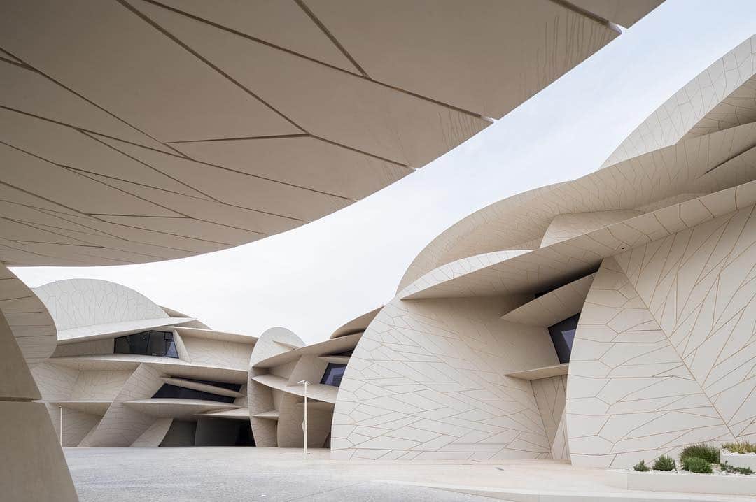 のインスタグラム：「"The museum’s architecture and structure symbolize the mysteries of the desert’s concretions and crystallizations, suggesting the interlocking pattern of the bladelike petals of the desert rose." —Jean Nouvel  The National Museum of Qatar, designed by Jean Nouvel, recently opened to the public in Doha. The new 560,000-square-foot museum comprises a series of interlocking discs, inspired by the desert rose, a flower-like cluster of gypsum crystals. Find out more via the link in our bio! __________ #JeanNouvel #NMoQ #IwanBaan @ateliersjeannouvel @nmoqatar @iwanbaan Photos: © Iwan Baan」
