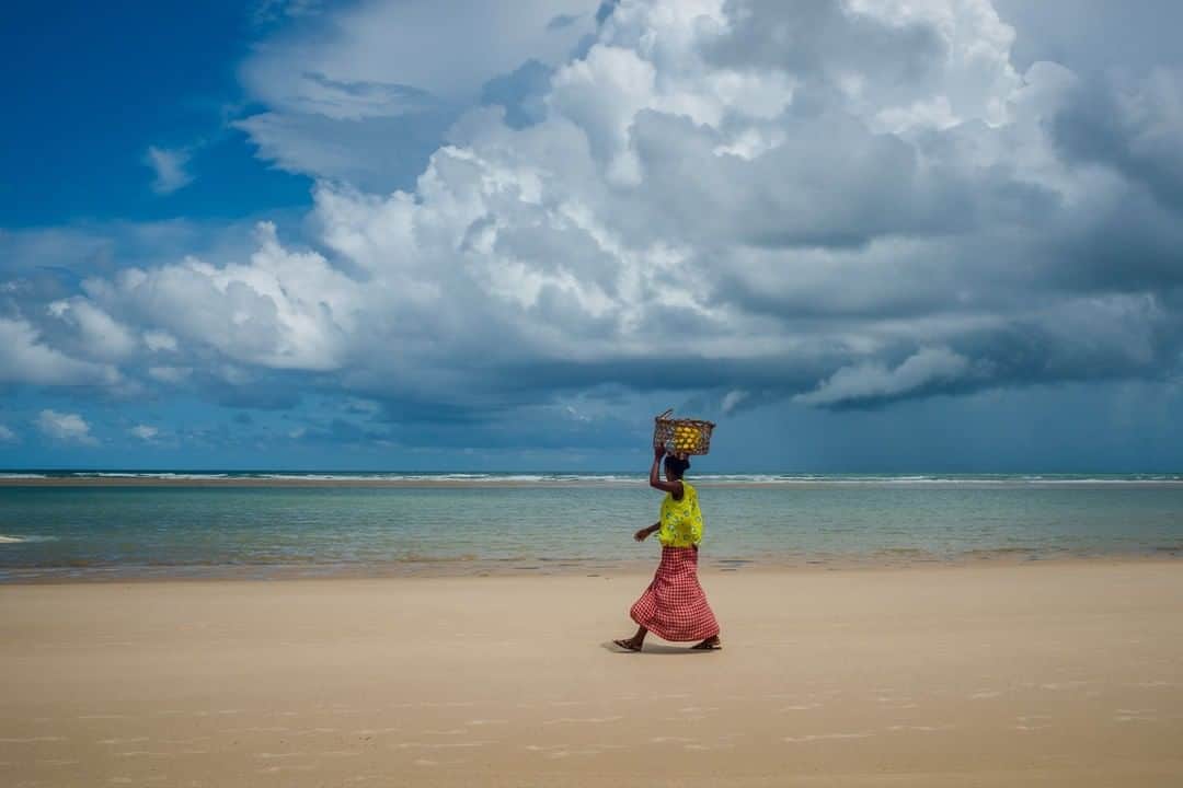 National Geographic Travelさんのインスタグラム写真 - (National Geographic TravelInstagram)「Photo @CristinaMittermeier | In the small fishing town of Morondava, Madagascar, a Vezo woman keeps an eye on the storm rolling in. The ocean sustains this coastal community, and its patterns influence the lifestyles of the local people. As the men are out at sea in fishing boats, women and children try their luck fishing from the beach. #FollowMe at @CristinaMittermeier and explore my feed for more photos of communities that directly depend on the health of our oceans. #Madagascar #ocean #community #fishing」3月18日 4時01分 - natgeotravel