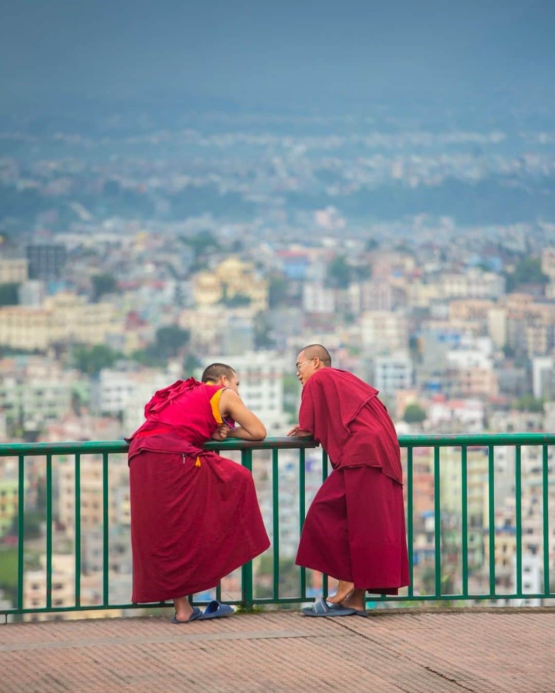 National Geographic Travelさんのインスタグラム写真 - (National Geographic TravelInstagram)「Photo by @emilypolar | Two monks having a little chat at Kopan Monastery above the urban valley of Kathmandu after a refreshing monsoon shower. To see more of this simple yet enchanting world follow @emilypolar #Nepal #Kopan #Kathmandu」3月19日 7時01分 - natgeotravel