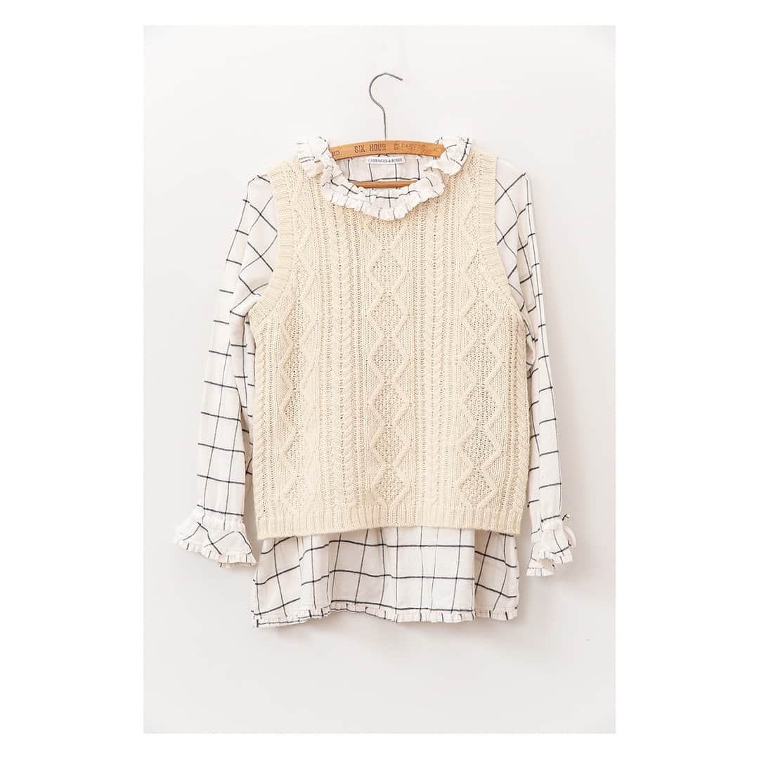 キャベジズ&ローゼズのインスタグラム：「The Blondie Blouse in beautiful brushed check Japanese cotton features wonderfully feminine details 🎀 The drawstring neck can be tightened to create a more formal stand up collar or worn loosely for relaxed open look. She is pictured here with the charming Charlie vest in a gorgeous mixed wool cable knit #springarrivals #ss19 #springoutfit #cableknit #layersonlayers #japanesecotton #knitwear #ruffles #cabbagesandroses #cabbagesandrosesfashion @christina_strutt @cabbagesandroses_shop 👆Link In Bio👆」