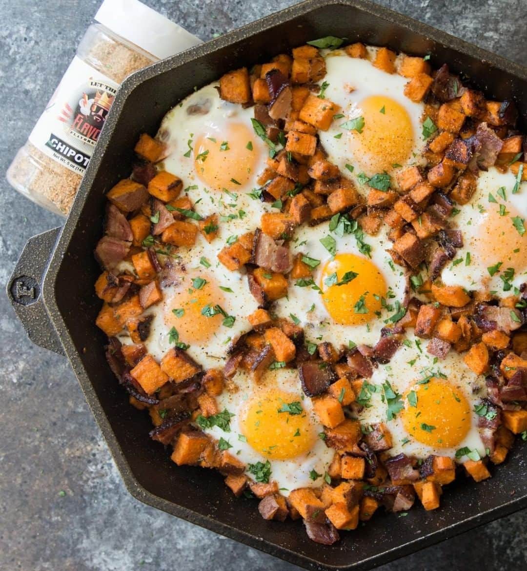 Flavorgod Seasoningsさんのインスタグラム写真 - (Flavorgod SeasoningsInstagram)「Sweet Potato, Bacon and Egg Skillet 🥘🥘🥘⁣ .⁣ Made with:⁣ 👉 #flavorgod Chipotle⁣ 👉 #flavorgod Pink Salt & Pepper⁣ -⁣ On Sale here ⬇️⁣ Click the link in the bio -> @flavorgod⁣ www.flavorgod.com⁣ .⁣ INGREDIENTS:⁣ 1-1.5 lbs sweet potatoes, diced⁣ 1 lb bacon⁣ 6-8 eggs, room temp is best⁣ 2 tbsp solid cooking fat⁣ 1 tsp FlavorGod Pink S+P⁣ 1 tbsp FlavorGod Chipotle⁣ cilantro to garnish⁣ ⁣ DIRECTIONS:⁣ Place bacon on baking sheet and cook in 400F oven for about 15-20 minutes, or until done. Set aside on paper towels.⁣ .⁣ While bacon is cooking, heat ghee in 12" cast iron skillet over med-high, then add diced sweet potatoes. Season with pink s+p and chipotle seasonings. Cook potatoes for about 10-15 minutes, stirring a few times. Potatoes should be fork tender.⁣ .⁣ Add bacon and stir into potatoes. With a spoon, make little holes to crack the eggs into. You can transfer the skillet to the oven for about 7 minutes to let egg whites set, or turn heat down and cover with a lid to cook eggs.⁣ ⁣ Garnish with cilantro and more flavorgod!」3月20日 22時00分 - flavorgod