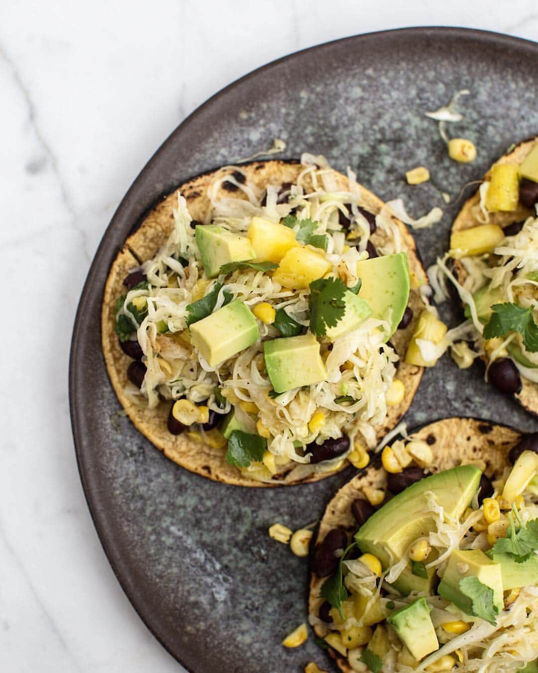 Whole Foods Marketさんのインスタグラム写真 - (Whole Foods MarketInstagram)「Sure, it's not #TacoTuesday but we'll make these #tacos with pineapple and jalapeño slaw from @onepartplant any day of the week! 🌮 Check out today's Story to see how she made the 🍍slaw and get the full recipe details below.👇#Pineapple #MakesMeWhole #Sponsored . . . I know pineapple and pizza is a thing…but I’m more of a pineapple and taco girl. And this Pineapple Jalapeño Slaw is the perfect way to make that happen. It’s only a handful of ingredients and you can whip it up in under 20 minutes. ⁣  I loaded up my tacos with avocado and black beans and then topped with the slaw and some hot sauce. Sooooo good! Check out the recipe below. But first! Have you made a pineapple dish yet this month? I want to see it! ⁣ ⁣ Make sure to tag it with #onepartplantxwholefoods for a chance to be featured here and at wholefoods. If you need more inspiration, just ask here or DM and I can give you some recipe ideas.  Pineapple Jalapeño Slaw ⁣ 3 cups cabbage, sliced thin ⁣ 1 cup roasted or grilled corn⁣ 1 cup pineapple, diced ⁣ 1 small jalapeño, diced ⁣ Juice of 1 lime ⁣ Handful of chopped cilantro ⁣ ⁣ Mix all ingredients in a bowl. Add a little salt. Stir again. Taste and add more lime juice, salt, or jalapeño for more heat.  #Sponsored #Pineapple #MakesMeWhole⁣ Photo: Timothy Pakron via @onepartplant」3月23日 1時31分 - wholefoods