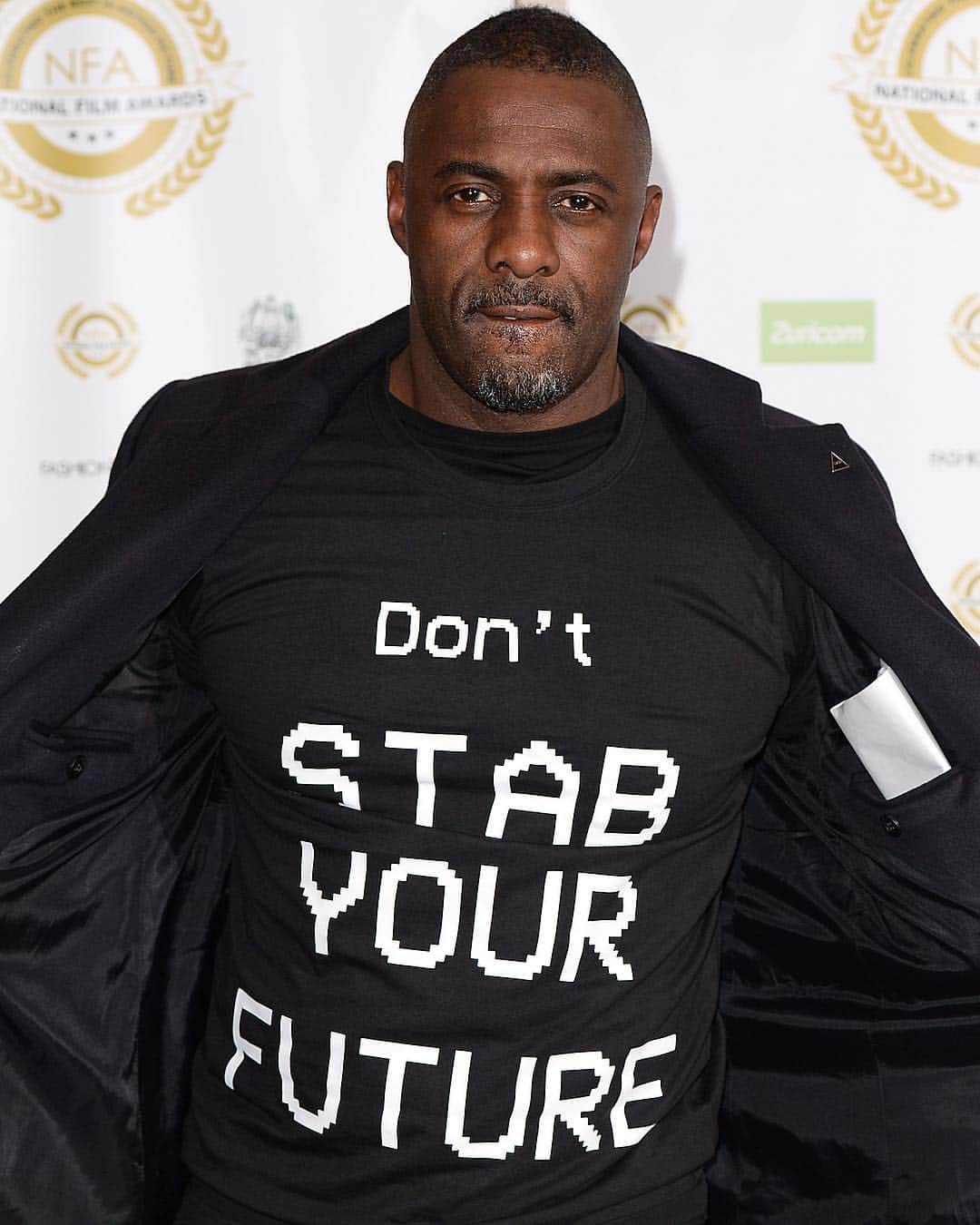 Just Jaredさんのインスタグラム写真 - (Just JaredInstagram)「@idriselba wears a “Don’t Stab Your Future” shirt referencing the rising incidents of knife crimes in London to the 2019 National Film Awards. He was joined by fiancée @sabrinadhowre on the red carpet.  #IdrisElba #SabrinaDhowre #NationalFilmAwards Photos: Getty」3月28日 15時07分 - justjared