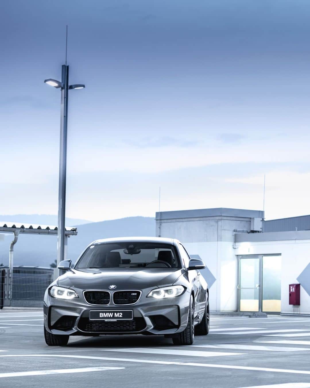 BMWのインスタグラム：「Thrill at first sight. BMW M2 Coupé. #BMWrepost @MerkPhotography #BMW #M2 #BMWM __ BMW M2 Coupé: Fuel consumption in l/100 km (combined): 8.5. CO2 emissions in g/km (combined): 199. The values of fuel consumptions, CO2 emissions and energy consumptions shown were determined according to the European Regulation (EC) 715/2007 in the version applicable at the time of type approval. The figures refer to a vehicle with basic configuration in Germany and the range shown considers optional equipment and the different size of wheels and tires available on the selected model. The values of the vehicles are already based on the new WLTP regulation and are translated back into NEDC-equivalent values in order to ensure the comparison between the vehicles. [With respect to these vehicles, for vehicle related taxes or other duties based (at least inter alia) on CO2-emissions the CO2 values may differ to the values stated here.] The values of the vehicles are preliminary. The CO2 efficiency specifications are determined according to Directive 1999/94/EC and the European Regulation in its current version applicable. The values shown are based on the fuel consumption, CO2 values and energy consumptions according to the NEDC cycle for the classification. For further information about the official fuel consumption and the specific CO2 emission of new passenger cars can be taken out of the „handbook of fuel consumption, the CO2 emission and power consumption of new passenger cars“, which is available at all selling points and at https://www.dat.de/angebote/verlagsprodukte/leitfaden-kraftstoffverbrauch.html.」