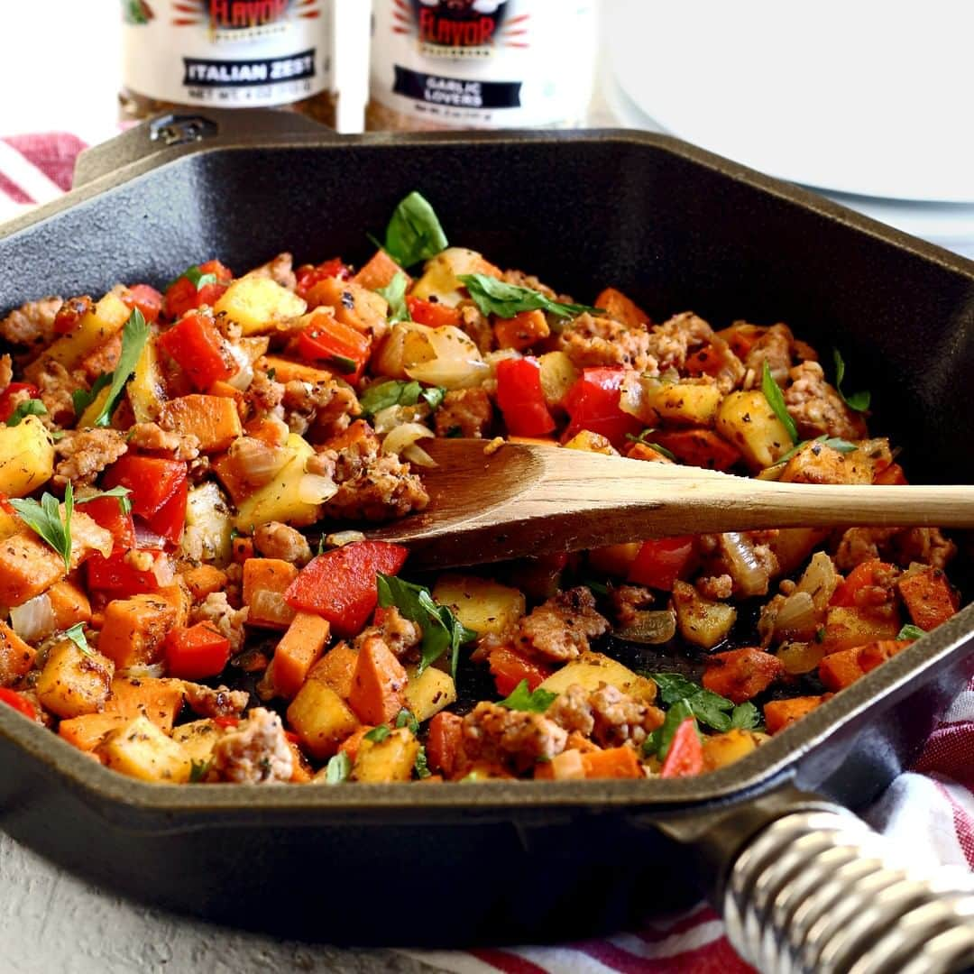 Flavorgod Seasoningsさんのインスタグラム写真 - (Flavorgod SeasoningsInstagram)「SAUSAGE & SWEET POTATO HASH⁣ ⁣ Here's a simple but hearty hash – it's especially awesome for breakfast topped with an egg! Features @flavorgod GARLIC LOVERS & ITALIAN ZEST seasonings.⁣ ⁣ *From @paleo_newbie_recipes:⁣ ⁣ INGREDIENTS:⁣ ⁣ 1 Tbsp olive oil⁣ 1/2 medium onion, chopped⁣ 1/2 pound bulk sausage (your choice)⁣ 1 clove garlic, minced⁣ Flavor God GARLIC LOVERS & ITALIAN ZEST seasonings⁣ 1/2 large yam, peeled and cubed small⁣ 1/2 large white sweet potato, peeled and cubed small⁣ 1 red bell pepper, seeded and diced⁣ Fresh parsley leaves, chopped (for garnish)⁣ ⁣ ⁣ INSTRUCTIONS:⁣ ⁣ In a skillet over medium heat, add olive oil and onion. Cook about 4 minutes, then add sausage. Sprinkle with Flavor God GARLIC LOVERS & ITALIAN ZEST seasonings as desired. Cook until sausage is browned, then add the garlic. Cook just 1 more minute, then remove mixture from pan and set aside.⁣ --⁣ In the same skillet, add more oil if needed and then the cubed yam and sweet potato. Apply Flavor God GARLIC LOVERS & ITALIAN ZEST seasonings liberally to the potatoes. Continue cooking about 15 minutes. As potatoes soften, add the diced bell pepper. Cook until potatoes are tender.⁣ --⁣ Add the meat mixture you set aside back to the skillet. Stir to heat everything through, garnish with fresh parsley, and serve.」4月2日 22時00分 - flavorgod