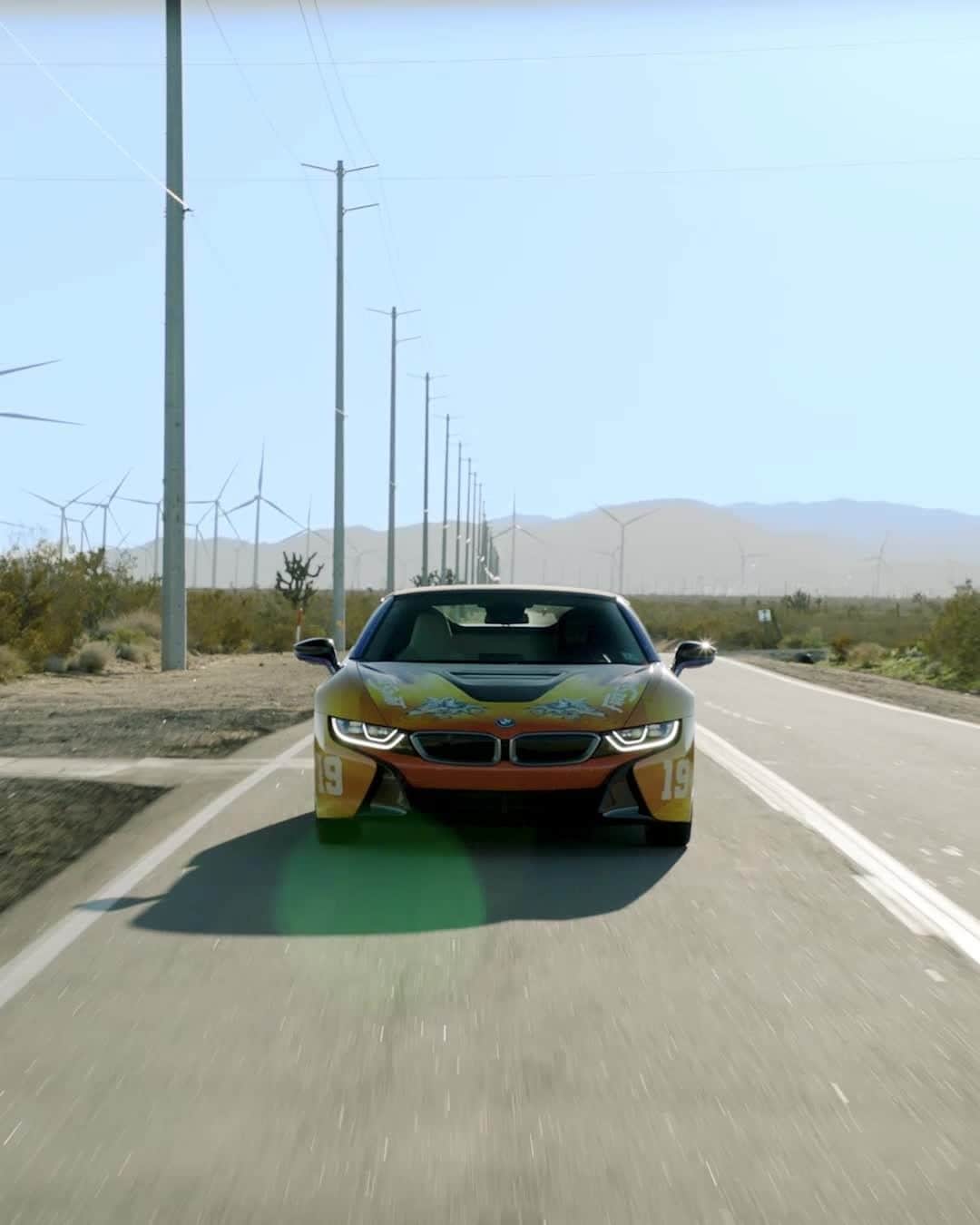 BMWのインスタグラム：「Unconstrained freedom meets the free spirit. The BMW i8 Roadster is ready for the #RoadToCoachella. Designed by @thegr8khalid.  #BMWxKhalid #BMW #BMWi8 @BMWi __ BMW i8 Roadster: Energy consumption in kWh/100 km (combined): 14.5. Fuel consumption in l/100 km (combined): 2.0. CO2 emissions in g/km (combined): 46. The values of fuel consumptions, CO2 emissions and energy consumptions shown were determined according to the European Regulation (EC) 715/2007 in the version applicable at the time of type approval. The figures refer to a vehicle with basic configuration in Germany and the range shown considers optional equipment and the different size of wheels and tires available on the selected model. The values of the vehicles are already based on the new WLTP regulation and are translated back into NEDC-equivalent values in order to ensure the comparison between the vehicles. [With respect to these vehicles, for vehicle related taxes or other duties based (at least inter alia) on CO2-emissions the CO2 values may differ to the values stated here.] The CO2 efficiency specifications are determined according to Directive 1999/94/EC and the European Regulation in its current version applicable. The values shown are based on the fuel consumption, CO2 values and energy consumptions according to the NEDC cycle for the classification. For further information about the official fuel consumption and the specific CO2 emission of new passenger cars can be taken out of the „handbook of fuel consumption, the CO2 emission and power consumption of new passenger cars“, which is available at all selling points and at https://www.dat.de/angebote/verlagsprodukte/leitfaden-kraftstoffverbrauch.html.」