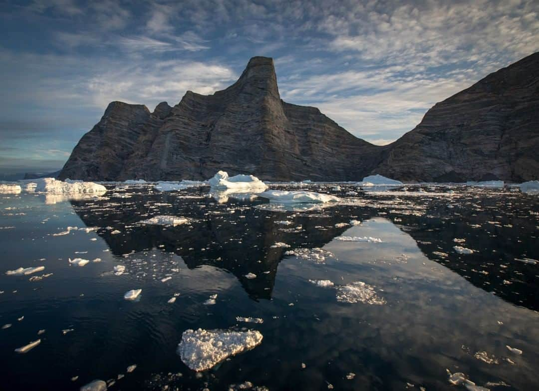 National Geographic Travelさんのインスタグラム写真 - (National Geographic TravelInstagram)「Photo by @acacia.johnson | Dramatic mountains rise from the sea in Scoresbysund, East Greenland. This massive fjord system, famous for its glaciers, ice and stunning landscapes, is also a gateway to Northeast Greenland National Park - the largest national park in the world. August and September are my favorite times to travel here, when the tundra is changing colors and dark nights occasionally offer aurora sightings. Follow me at @acacia.johnson for more adventures from the Arctic and beyond. #Greenland #Scoresbysund #EastGreenland」4月4日 7時05分 - natgeotravel