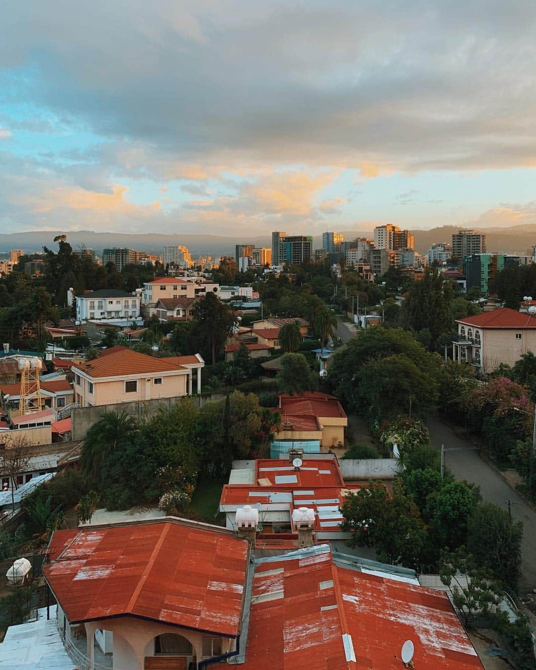 Cubby Grahamのインスタグラム：「Here we go! Quick stopover in Addis Ababa. Woke up just as the sun started to rise over the capital city and the morning colors began to bounce off the buildings. In a few hours we’ll be catching another flight to visit our local partners in the North. Can’t wait to spend the next few weeks with them! 🇪🇹 #charitywaterethiopia」