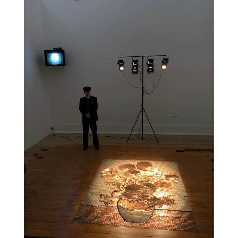 テート・ギャラリーさんのインスタグラム写真 - (テート・ギャラリーInstagram)「Rose Finn-Kelcey's 'Bureau de Change' 1987 is a large recreation of Vincent van Gogh's 'Sunflowers', made using coins. 🌻🌻🌻 ⠀⠀⠀⠀⠀⠀⠀ The work was created shortly after Van Gogh's painting sold at auction for the then record price of £24.5 million. It's situated somewhere between installation and performance; a uniformed guard sits beside the coin 'painting' at all times and a video monitor displays its CCTV image. The artist said the fact that ‘most artists are unable to make a living out of their work struck me as ironic. I realised that here was the imagery that would allow me to bring together both the material and the conceptual.’ ⠀⠀⠀⠀⠀⠀⠀ Currently on free display at Tate Britain. Explore in today's story!」5月3日 1時41分 - tate