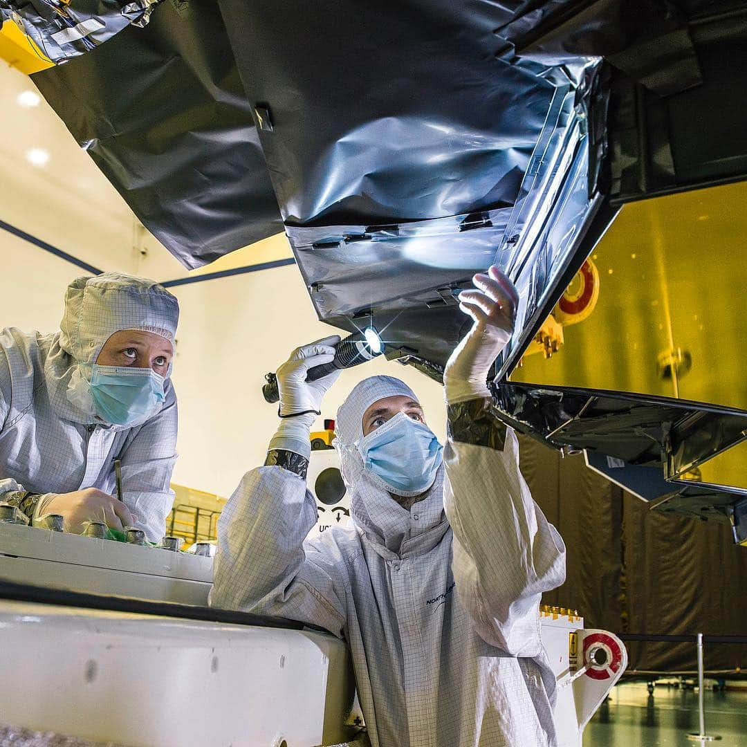 NASAさんのインスタグラム写真 - (NASAInstagram)「The @NASAWebb Telescope isn’t covered by a protective tube like @NASAHubble, instead technicians and engineers designed innovative shielding behind the primary mirrors — to keep out excess light.  Image 1: Northrop Grumman blanket technician Ann Meyer and Ball Aerospace optical engineer Larkin Carey inspect the protective barrier behind Webb’s primary mirror. This lightweight blanketing plays an important role on the observatory as it blocks undesirable light from reaching the telescope’s sensitive infrared sensors.  Image 2: To fit inside the Ariane 5 rocket that Webb will ride to space, some of its mirrors are designed to fold, and deploy to full size once in orbit. Shown here: technician Ricardo Pantoja performs a routine inspection of NASA Webb’s innovative blanketing along the connection point of its deployable primary mirror segments.  To observe objects in the distant cosmos, and to do science that’s never been done before, the Webb telescope’s scientific instruments need to be cooled down to a temperature so cold, it would freeze the oxygen in Earth’s atmosphere solid.  Intentionally chilling the telescope mirrors and instruments with innovative technologies and intelligent spacecraft design allows them to be far more sensitive to faint infrared light. Infrared can be described simply as heat, and if Webb’s components are cool, they are far more capable at observing faint heat signatures from the distant universe.  Image Credits: NASA/Chris Gunn  #jwst #space #telescope #webb」4月12日 23時05分 - nasagoddard