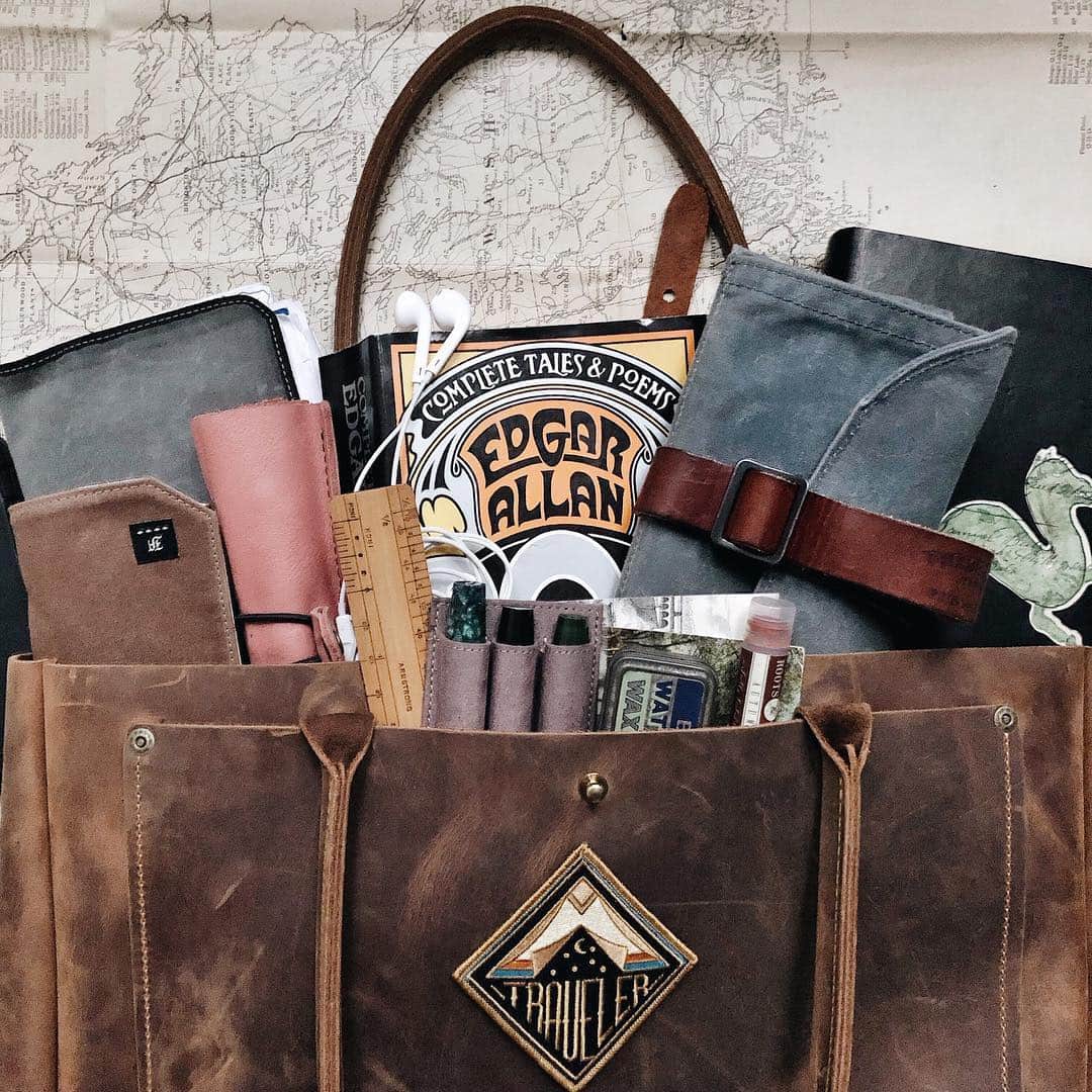 Catharine Mi-Sookさんのインスタグラム写真 - (Catharine Mi-SookInstagram)「Packing for adventures with the brand spanking new Marfa Tote by @woodandfaulk! I did a poll of which Marfa Tote that you all thought I might choose - Harvest versus Roughout. I only changed my mind about half a dozen times but I ended up setting my cap at the Harvest! The leather is gorgeously rugged, weatherproof, durable and smells divine. Perfect for springtime and summer adventures! I can’t wait to see the stories it will carry and how this beautiful leather will age along with it. Be it a picnic, overnight trip, day bag, stationery treasure chest or my Mary Poppins bag holding an endless supply of essentials when I’m with my main squeeze and our little guy, this will come in handy for practically everything while suiting our gypsy-hearted style. A win win all around. Now onward to the road! . . . . In my bag: Vagabond Notebook, Watch Roll, Three Pen Insert, Models 46 & 45L Fountain Pens by @franklinchristoph. Foundlings Journal & Mini Sendak Artist Roll by @pegandawl. XLarge Leather Pencil Case by @galen_leather. TN Passport at @nomadostore. Lip Balm in Autumn @rootsandcrownspdx. Flower Crown & my husband’s Edgar Allan Poe book (one of our favorites). . . . . #woodandfaulk #leathertote #inmybag #whatsinmybag #leatherbags #madeintheusa #pdxstyle #madeinpdx #makersgonnamake #pegandawl #leatherjournal #franklinchristoph #vagabondnotebook #tnlove #fountainpens #stationerylover #loveforanalogue #galenleather #midoripassport #トラベラーズノート #midoritravelersnotebook #nomadostore #flatlaystyle #flatlays #flatlaylove #thingsorganizedneatly #smallbusinesssaturday #travelbags」4月14日 9時05分 - catharinemisook