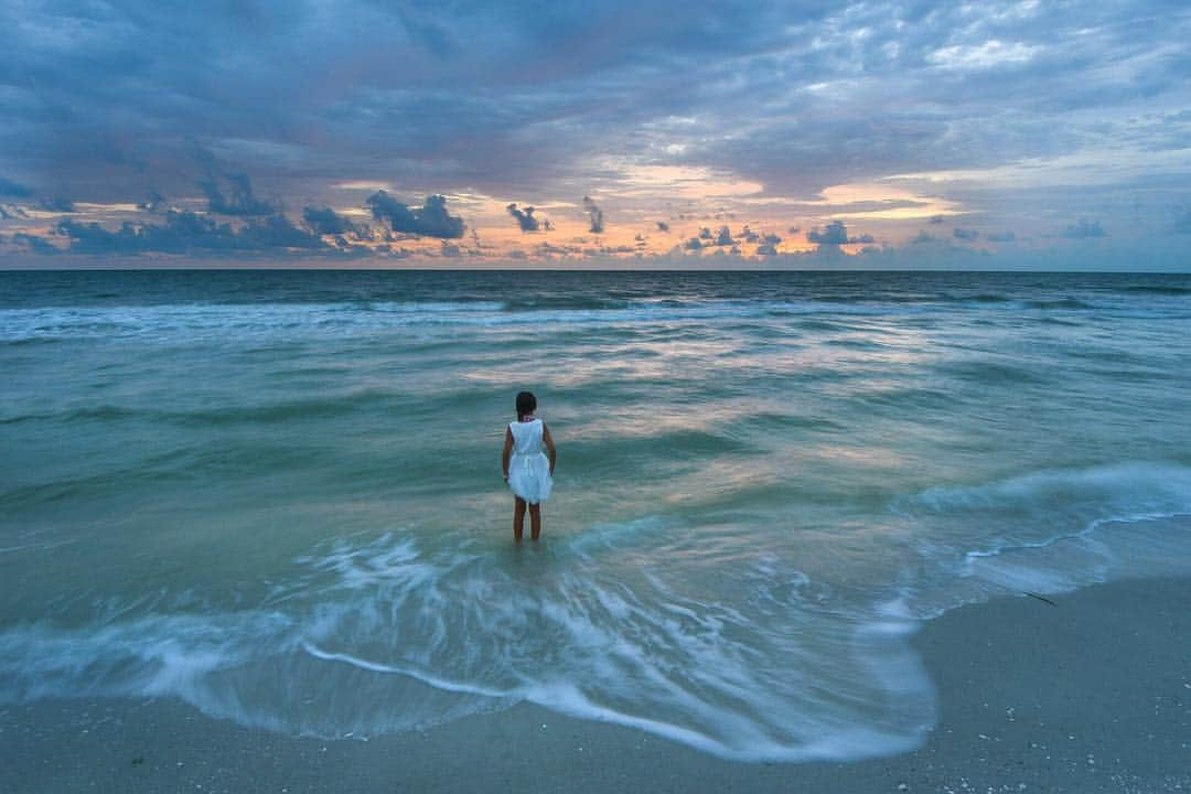 National Geographic Travelさんのインスタグラム写真 - (National Geographic TravelInstagram)「Photo by @carltonward // sponsored by @VISITFLORIDA // While playing in the surf after a family photo shoot, a young girl pauses for a quiet moment to look out over the Gulf of Mexico at Delnor-Wiggins Pass State Park on Florida's southwest coast near Naples. The state park protects a mile of barrier island beaches near the pass where the Cocohatchee River flows into the Gulf. Barefoot Beach County Preserve provides access to explore the other side of the river. I see myself in this picture, staring out over the waves many times in my youth. The Gulf of Mexico is part of me, always calling me back, and I am thankful that state parks like this preserve the natural wonders for residents and visitors alike. // @VISITFLORIDA and explore 175 State Parks, hundreds of freshwater springs, infinite mangrove tunnels, and hidden caverns. Let your adventure begin. #LoveFL」4月17日 1時03分 - natgeotravel