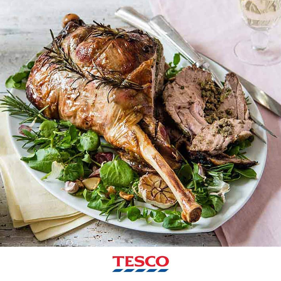Tesco Food Officialさんのインスタグラム写真 - (Tesco Food OfficialInstagram)「Does our half-price leg of lamb have you dreaming of this week’s #Easter feast? Stuffed with peppery watercress and anchovies, this roast lamb recipe ticks all the traditional boxes, but adds a few modern twists. Redcurrant gravy anyone? #HopToTesco🐰 and add it to your Easter basket.  Ingredients  1 lamb leg joint, approx 2.3kg 1 tbsp olive oil 1 garlic bulb, cut horizontally through the centre 200ml white wine 2 tbsp plain flour 250ml lamb stock 1 tsp redcurrant jelly or cranberry sauce For the stuffing 1 red onion, finely chopped 2 large garlic cloves, chopped 1 tbsp chopped fresh rosemary leaves, plus extra sprigs for roasting 1 tbsp chopped fresh mint leaves 5 anchovy fillets, drained and chopped 1 lemon, zested 1½ x 85g bags watercress  Method  1. Preheat the oven to gas 7, 220°C, fan 200°C. To make the stuffing, blitz the onion, garlic, chopped herbs, anchovies, lemon zest and 85g watercress in a food processor to a rough paste; season.  2. Thoroughly dry the lamb with kitchen paper and place it, skin-side down, on a board. Cut a pocket in the thick part of the meat, cutting along the bone about halfway down, being careful not to cut all the way through.  3. Spoon as much of the stuffing as you can into the pocket, then tie the leg up with several pieces of kitchen string to close it, tucking the extra rosemary sprigs under the string. Press any leftover stuffing into the underside of the meat. Rub the lamb all over with oil and season well. Place in a snug-fitting, hob-safe roasting tin, along with the garlic bulb halves.  4. Roast for 20 mins, then reduce the oven to gas 5, 190°C, fan 170°C and continue to cook for 1 hr 5 mins, covering the lamb with foil if it browns too quickly. Pour over the wine and cook for a further 30 mins.  5. Transfer the joint to a warm serving dish and cover with foil to keep warm while you make the gravy.  6. Put the tin on the hob over a low heat, add the flour and whisk it into the pan juices. Whisk in the stock and redcurrant jelly, then simmer for 2 mins. Season and strain into a warm jug. Serve the lamb with the remaining watercress and the gravy.」4月17日 23時07分 - tescofood