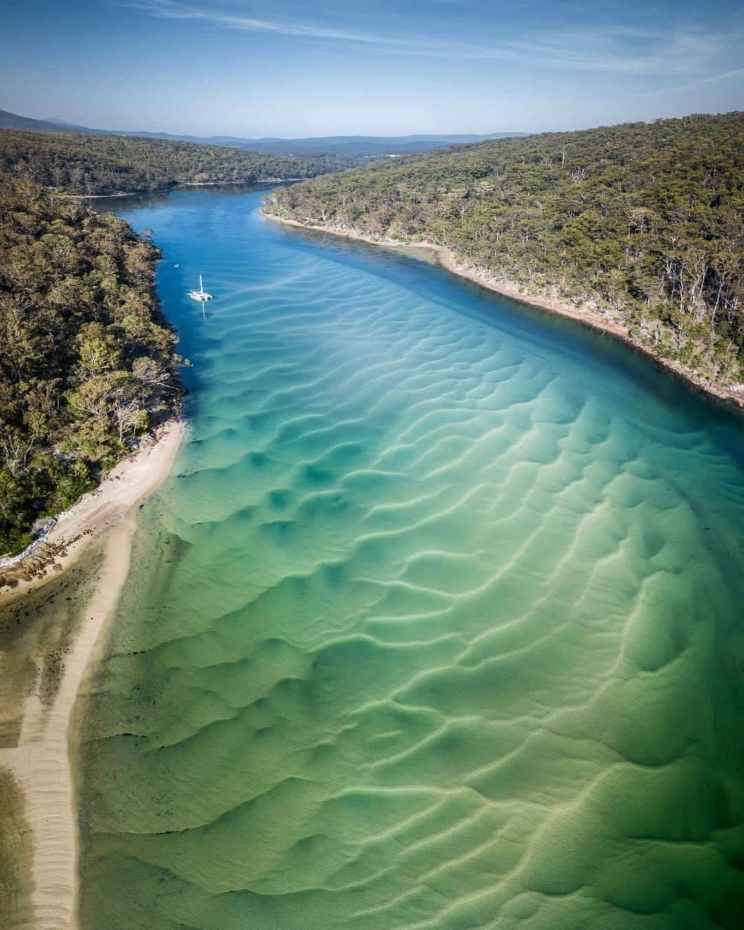 Australiaさんのインスタグラム写真 - (AustraliaInstagram)「The water clarity in @sapphirecoastnsw is CLEARLY top-notch! 💦 @davey_rogers enjoyed this view “looking upstream from #PambulaRiver mouth”, a beautiful spot located a six-hour drive south of @sydney in @visitnsw. One of the best ways to enjoy the tranquillity of the river and surrounding headlands is to stroll along the Pambula River walking track. The track starts at the #river mouth in #BenBoydNationalPark, and you can often spot dolphins and stingrays in the water along the way. TIP: Pack a picnic and find a secluded inlet to base yourself for a little break, and if it tickles your fancy, why not take a dip in the river to cool down and recharge before finishing the track.  #seeaustralia #newsouthwales #sapphirecoastnsw #naturephotography #travel」4月19日 4時00分 - australia