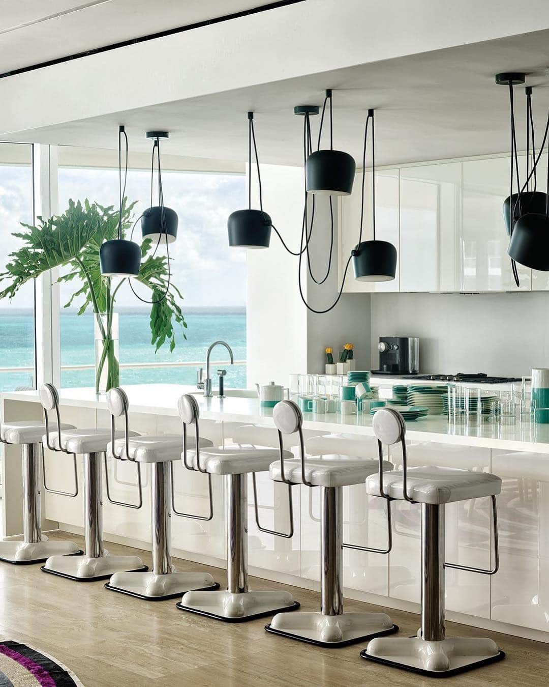 ELLE DECORさんのインスタグラム写真 - (ELLE DECORInstagram)「The glossy white kitchen in this @delphinereedkrakoff-designed Miami getaway offers a neutral counterbalance to the color-punched penthouse apartment, located in the city’s legendary Surf Club. “You go to Miami, and you feel the energy, the colorfulness, and the multiculturalism—we wanted to celebrate that spirit,” Krakoff’s client says of their new space. Link in bio for the full tour, as seen in our May 2019 issue. Photography by @thefacinator」4月21日 0時31分 - elledecor