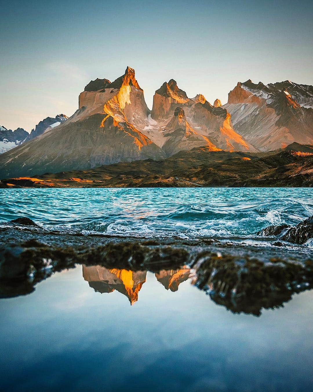 ティム・ケンプルのインスタグラム：「If you are lucky enough to get a clear morning, watching the sunrise on the Torres del Paine might be one of the most stunning on the planet. ⁣⁣ ⁣⁣ What makes the Paine unique amongst stunning mountain ranges, is how much the landscape changes as you move along it. The different valleys, and canyons that slice the peaks create a three dimensional picture that is always evolving. The famed ‘W’ hike is named as such because the different trails lead climbers and hikers deep into the valleys. The journey is magic for the eyes and the camera. ⁣ ⁣ Continuing the #EarthDay celebration with a few of my favorite peaks from around the globe. ⁣⁣ @camp4collective #camp4pix」