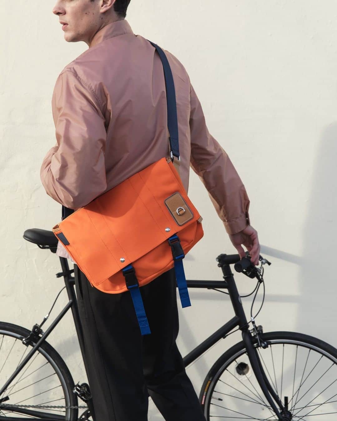 MR PORTERのインスタグラム：「⁣ Need a bag for cycling to work? Don't know what to wear to that wedding coming up? We're here to answer all your burning style questions.⁣ -⁣ So, drop us a comment with all your tricky clothing conundrums and we'll answer our favourites in The Daily on Friday. ⁣ -⁣ Jacket @prada (1095738), bag @loewe (1123113), trousers @noongoons (1109104) available now on MR PORTER. Bike by @tokyobikelondon.⁣」
