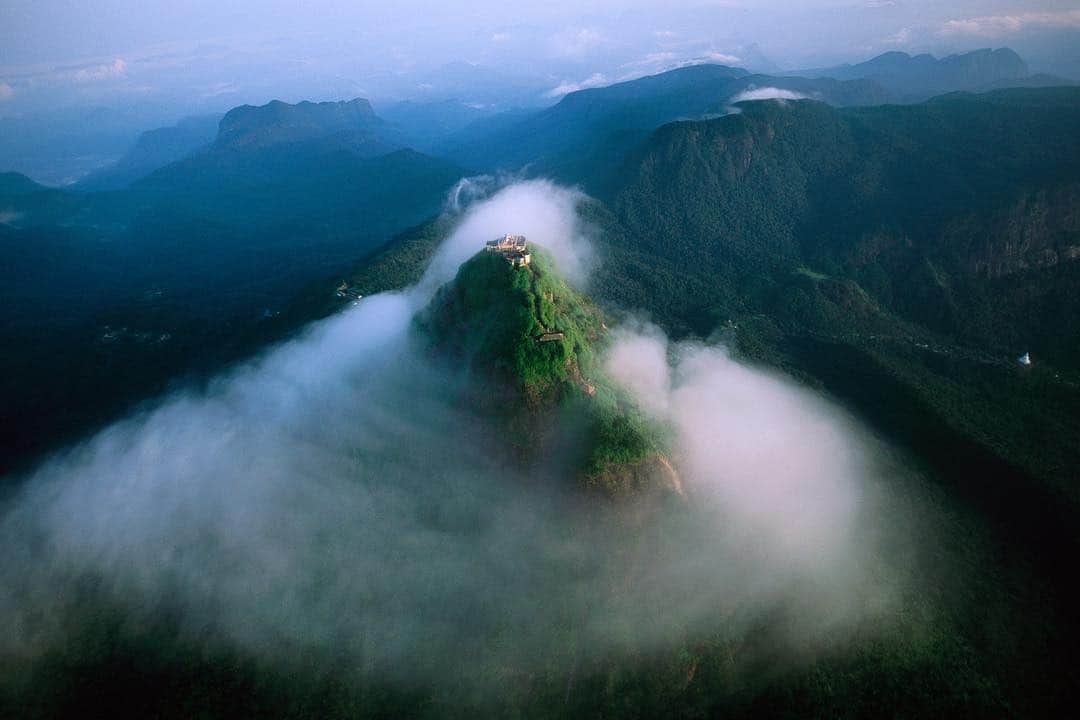 Michael Yamashitaさんのインスタグラム写真 - (Michael YamashitaInstagram)「Adam's Peak, known by many names, emerges from the morning mist. It is a reminder that there can be peace amongst the worlds religions. Sri Lanka’s landmark mountain is sacred to the world’s 4 largest religions. The sacred rock formation near the summit is thought to be Adam’s footprint by Christians and Muslims, Shiva’s by Hindus, and Buddha’s by Buddhists. An important pilgrimage site for these religions, most make the 4 hour climb at night, to be rewarded by a wonderful sunrise view. #SriPada #AdamsPeak #ShivaPadam #SriLanka」4月25日 4時57分 - yamashitaphoto