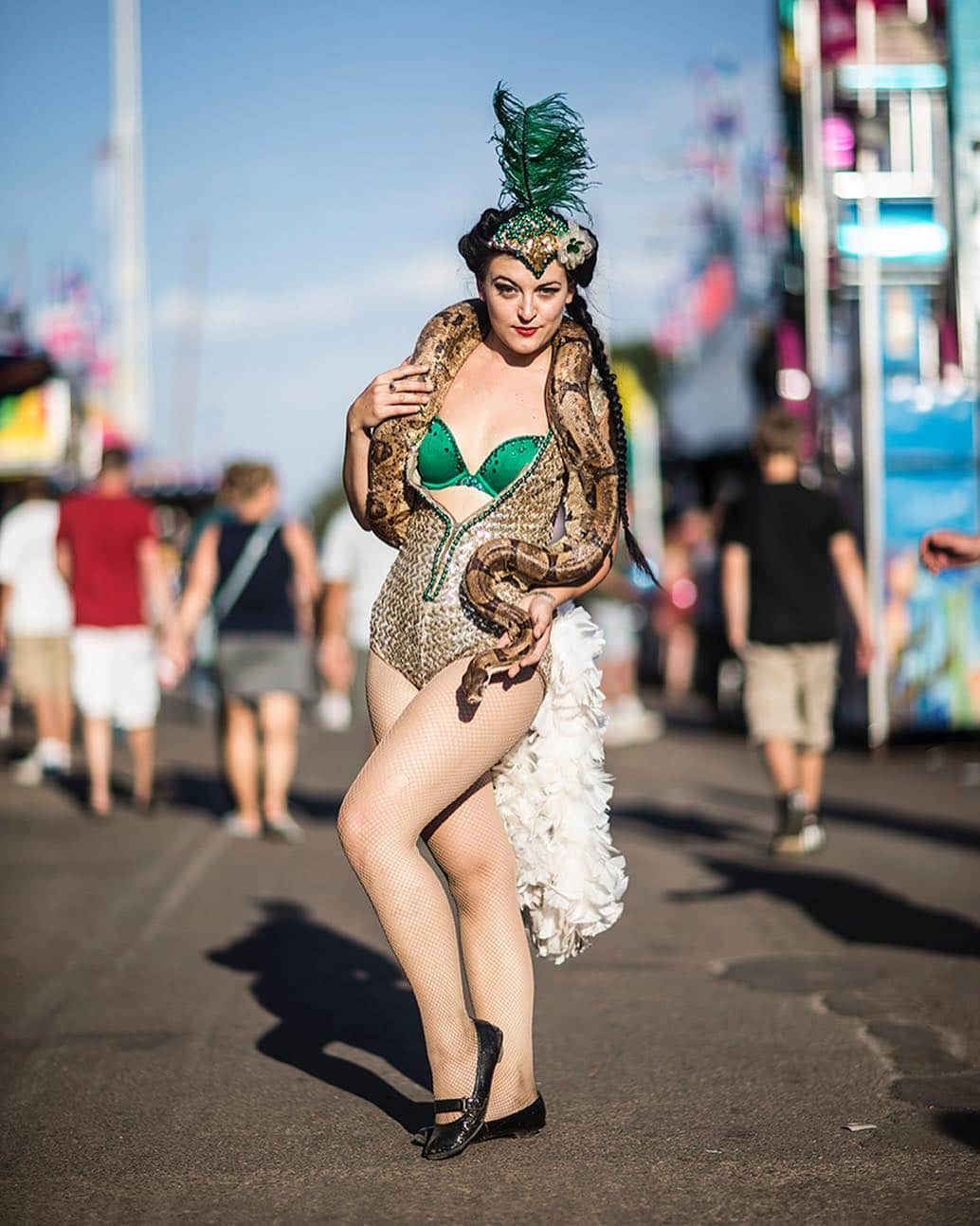 National Geographic Creativeさんのインスタグラム写真 - (National Geographic CreativeInstagram)「Photo by @brianlehmannphotography | A woman holds a 9 foot snake to invite people into the World of Wonders Circus sideshow at the Minnesota State Fair. #Minnesota #Circus #Snake」4月25日 6時10分 - natgeointhefield