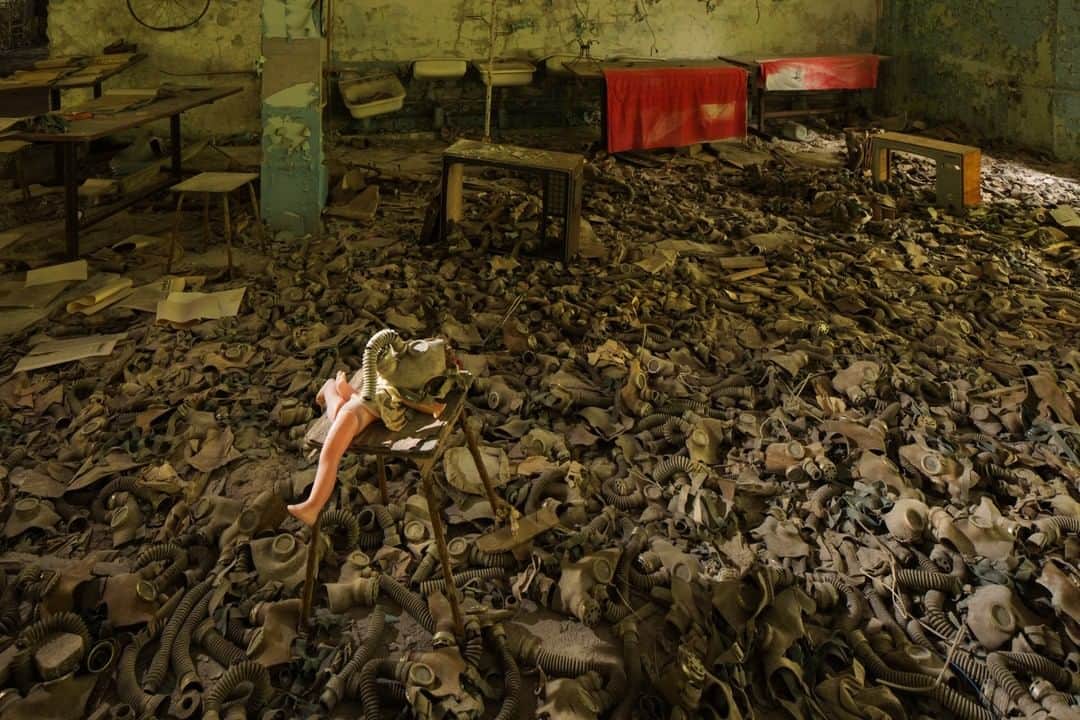 National Geographic Travelさんのインスタグラム写真 - (National Geographic TravelInstagram)「Photo by Gerd Ludwig @gerdludwig | Dolls, like this one, arranged among gas masks have become standard motif for tourists visiting the Chernobyl Exclusion Zone. In 2011, the Ukrainian government officially legalized tourism into the Zone. Today, the chilling ghost town of Pripyat is one of the biggest attractions, famous for its assemblies of children’s gas masks spread out on the floors of abandoned schools and kindergartens. To commemorate the 33rd anniversary of the world’s largest nuclear accident to date, I am posting photographs of the aftermath of the Chernobyl catastrophe on @gerdludwig. @thephotosociety #Chernobyl #Pripyat #nuclear #doll #gasmasks」4月26日 4時02分 - natgeotravel
