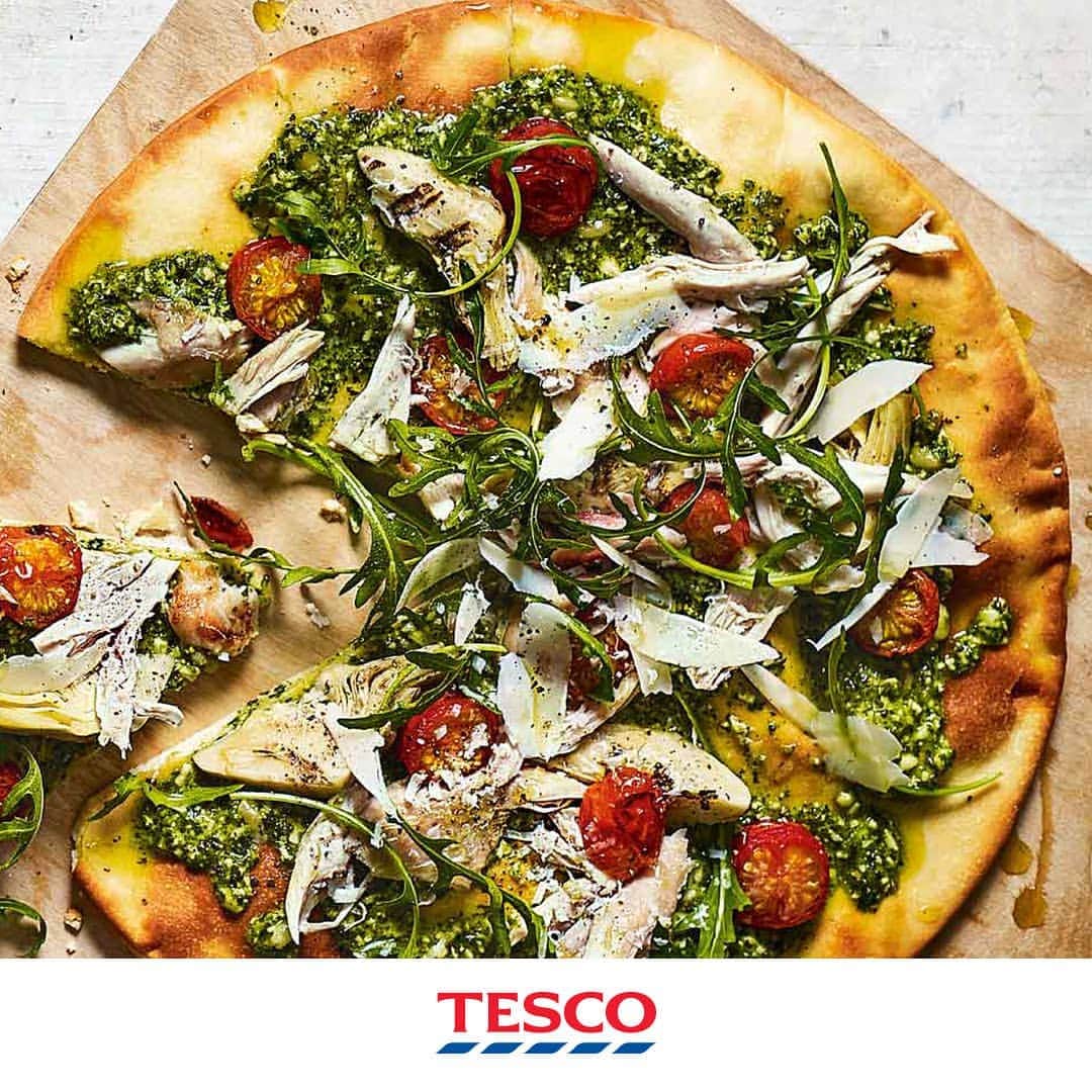 Tesco Food Officialさんのインスタグラム写真 - (Tesco Food OfficialInstagram)「End Friday with some amore - treat yourself to these easy chicken pesto pizzas. Succulent chicken drumsticks shredded onto a layer of pesto (instead of tomato paste), ready in 30 just minutes. #Fakeaway  Ingredients  2 cooked chicken drumsticks 2 x 280g ready-rolled round pizza dough bases ½ x 130g tub fresh pesto 140g tub chargrilled artichokes, drained 12 cherry tomatoes, halved 20g wild rocket 20g Parmesan shavings (optional)  Method  Preheat the oven to gas 7, 220°C, fan 200°C. Remove the meat from the drumsticks, discarding the skin and bones. Unroll the pizza bases on 2 baking trays. Spread the pesto over the bases, then arrange the chicken, artichokes and cherry tomatoes on top. Bake for 20-25 mins until the edges of the dough are golden. Scatter over the rocket and Parmesan, if using, and cut into slices to serve.」4月26日 21時12分 - tescofood