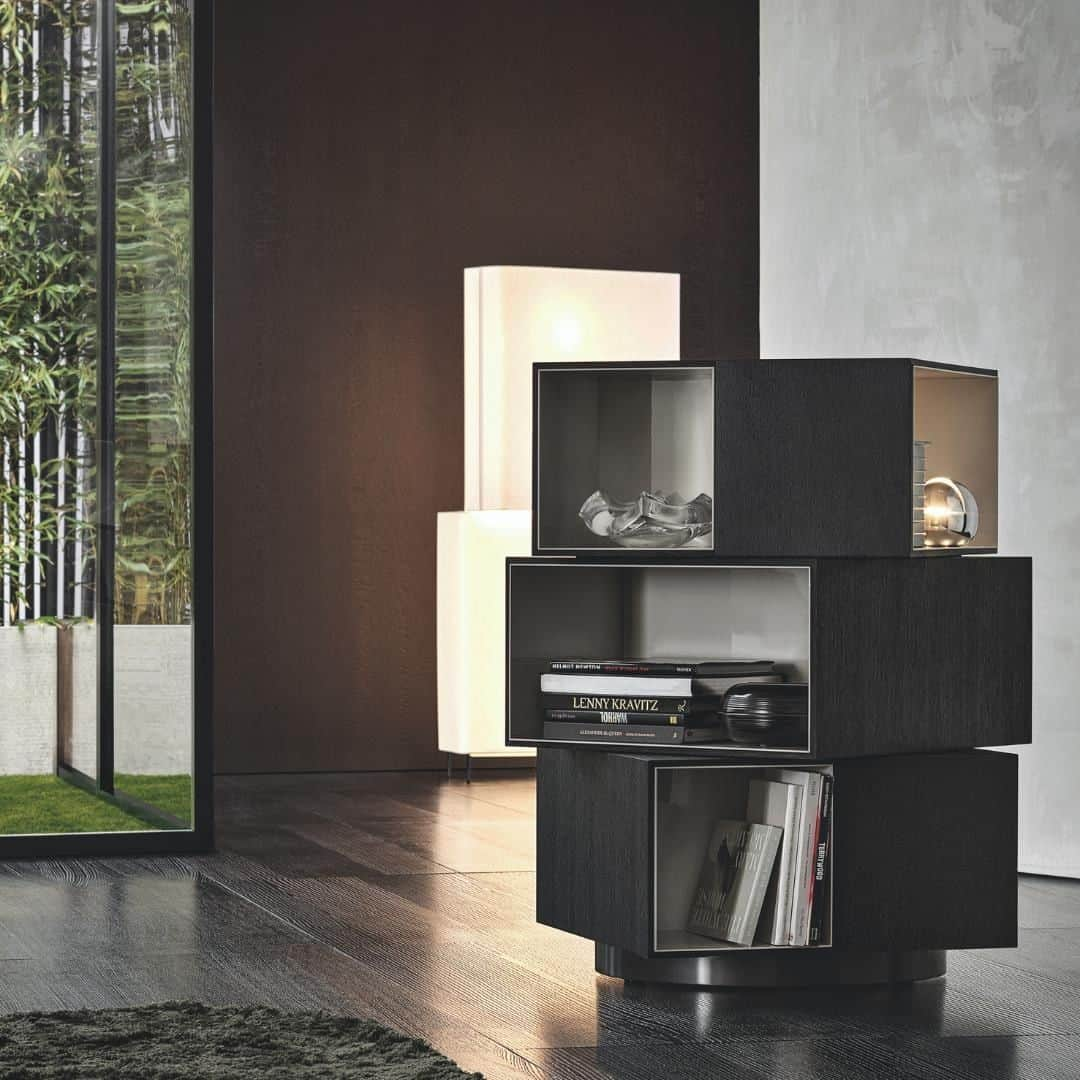 Minotti Londonさんのインスタグラム写真 - (Minotti LondonInstagram)「With its decidedly sculptural presence and the contrasting textures of the interiors and exteriors of its three volumes, the Page bookcase is inspired by works of modern art. Its misaligned blocks, set one on top of the other also call to mind contemporary architectures.  Fully swivelling, it is characterised by volumes in the form of parallelepipeds, with outer edges in Moka-coloured wenge wood and glossy painted Warm Grey-coloured interiors, and it stands on a circular base with a glossy Pewter-coloured finish.  A bold piece of furniture that is sure to turn heads, ideal in any part of the room, including the centre.  In addition to its function as a bookcase, Page can also be used as a contemporary display cabinet to accommodate objects or as a bar cabinet.  Tap the link in our bio to book your appointment to see the full collection and talk to one of our expert team about your project.  #furniture #furnituredesign #design #designer #designers #interiordesign #interiordesigner #minotti #minottilondon #luxury #luxurydesign #luxuryinterior」4月26日 15時20分 - minottilondon