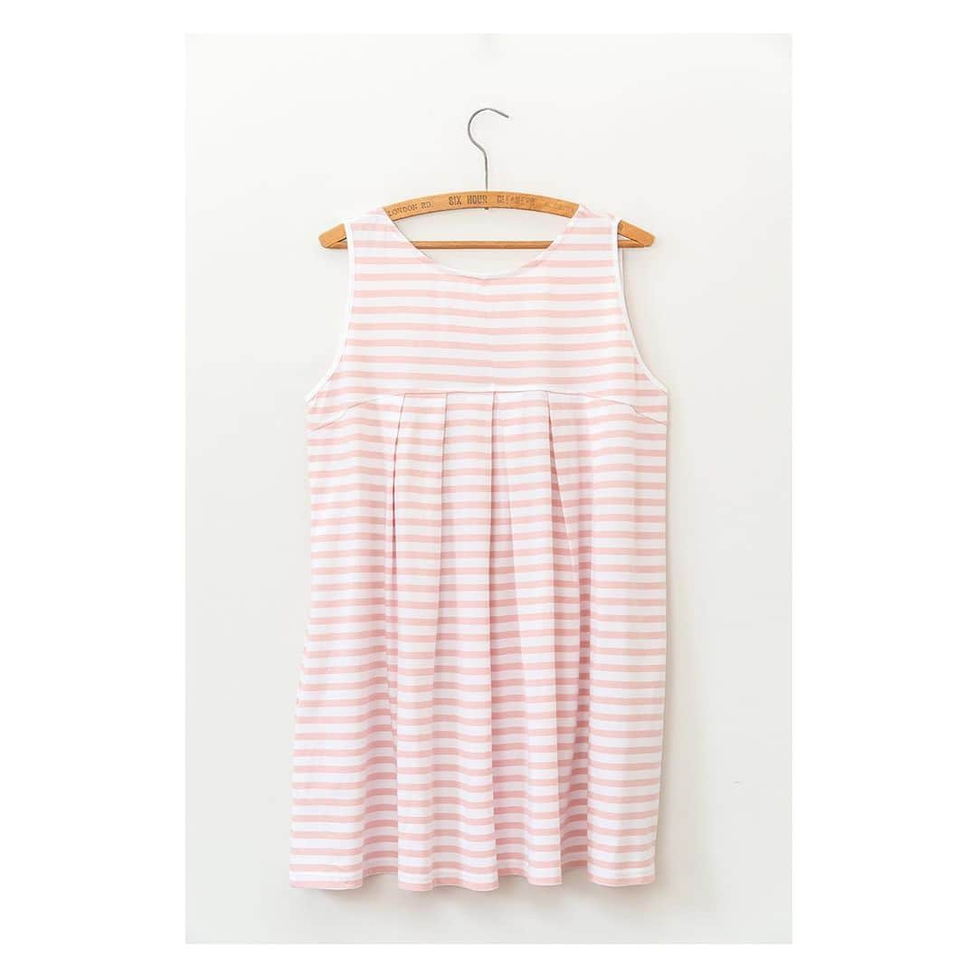 キャベジズ&ローゼズのインスタグラム：「Add a bit of flavour to your spring wardrobe with the Rosemary Smock Dress ❤️ Made from the prettiest pink stripe organic cotton, Rosemary has sewn down pleats which open at bust height and is cut in a very flattering A-line shape. Wear her on her own or layer with t-shirts and knits #pleateddress #organicjersey #slowfashionstyle #slowfashion #pinkdress🎀 #stripes #stripestyle #sleevelessdress #cabbagesandroses #cabbagesandrosesfashion @christina_strutt @cabbagesandroses_shop 👆Link In Bio👆」