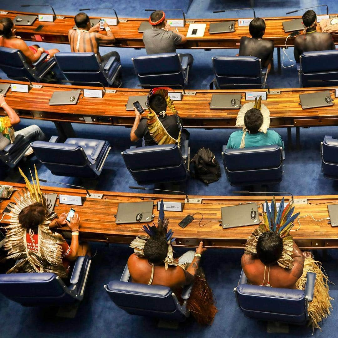 TIME Magazineさんのインスタグラム写真 - (TIME MagazineInstagram)「More than 1,000 indigenous people set up an encampment this week in Brasília to call for the protection of their land and cultural rights, which they view as under threat by Brazil's far-right leader Jair #Bolsonaro. Among the events, @apnews reports, lawmakers and more than 150 indigenous leaders discussed land rights and the role of communities in protecting the #environment. In these photographs, an indigenous woman stands in the fountain area of a government building during a protest on April 26, and indigenous leaders occupy senators' seats a day earlier during a special session in homage to indigenous people. Photographs by Carl De Souza and @sergiolimafoto—@afpphoto/@gettyimages」4月27日 4時21分 - time