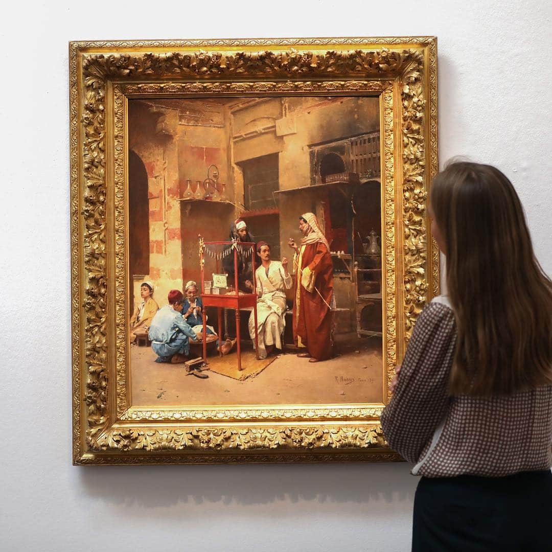 サザビーズさんのインスタグラム写真 - (サザビーズInstagram)「Painted in 1891, ‘The Tobacco Seller, Cairo’ by Raphael von Ambros depicts a busy stall outside a coffee shop in the streets of #Cairo. The development of a major cigarette industry in #Egypt in the late 19th century was unexpected, given that the cultivation and processing of tobacco in Egyptian and other peripheral Ottoman provinces was banned as part of a state tobacco monopoly. Tobacco traders from across the Ottoman Empire moved to Cairo to take advantage of a loophole in the law, namely that Egypt was outside of the monopoly because of its ‘de facto’ occupation by the British. Egyptian cigarettes became so popular in Europe and the United States that they inspired a larger number of locally produced versions, including the American Camel brand, established in 1913, which used on its packet three Egyptian motifs: the camel, the pyramids, and a palm tree. _ On view in our #London galleries this weekend as part of our annual Orientalist Sale on 30 April. #SothebysMiddleEast」4月28日 17時18分 - sothebys