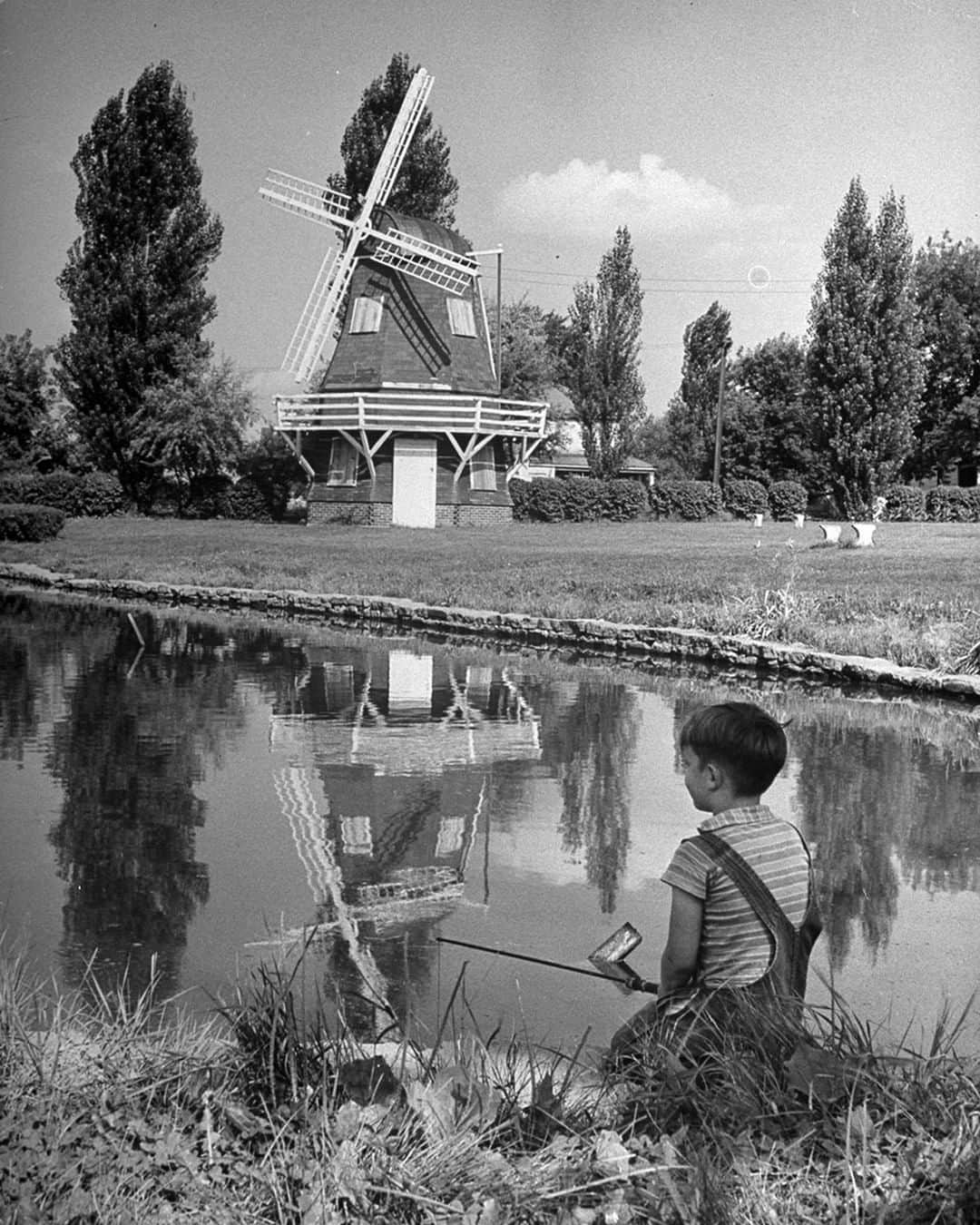 lifeさんのインスタグラム写真 - (lifeInstagram)「An outtake from the September 30, 1946 feature story: "IOWA CENTENNIAL: State Celebrates 100 Years of Progress." Pictured here is a young boy fishing in a river reflecting a Dutch windmill in Iowa. (Bob Landry—The LIFE Picture Collection/Getty Images) #windmills  #fishing #Iowa」4月28日 22時33分 - life