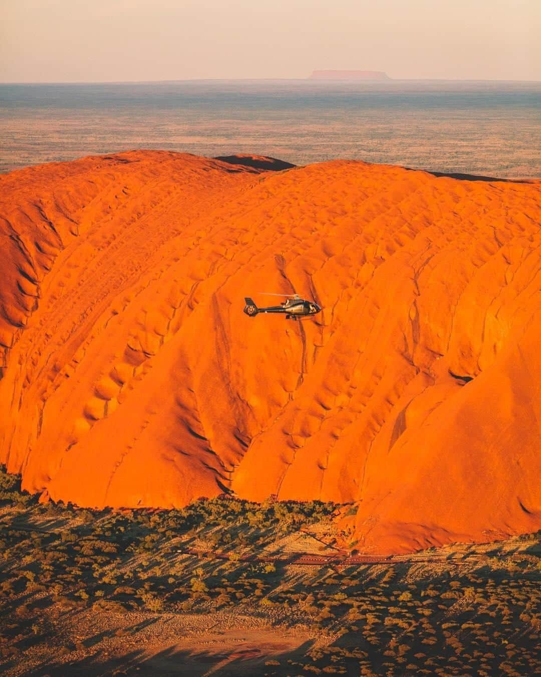 Australiaさんのインスタグラム写真 - (AustraliaInstagram)「If you’re heading to @visitcentralaus, you better book a seat on that chopper for seriously epic views 🚁 @saltywings captured this breathtaking photo of @exploreuluru with a drone, as part of a special project with @ntaustralia and the local Anangu people. Seeing this #outback icon from the air really makes you appreciate its enormous size and scale, as this rock formation is 348 metres high (for a bit of perspective, that’s taller than the Eiffel Tower in Paris!) TIP: Stay at #AyersRockResort or @longitude131, both resorts can arrange whatever sightseeing experiences you’d like, from walking tours, segways and camel rides to helicopters, so you can take in this natural wonder from all angles.  #seeaustralia #NTaustralia #redcentreNT #naturephotography#travel」5月24日 4時00分 - australia