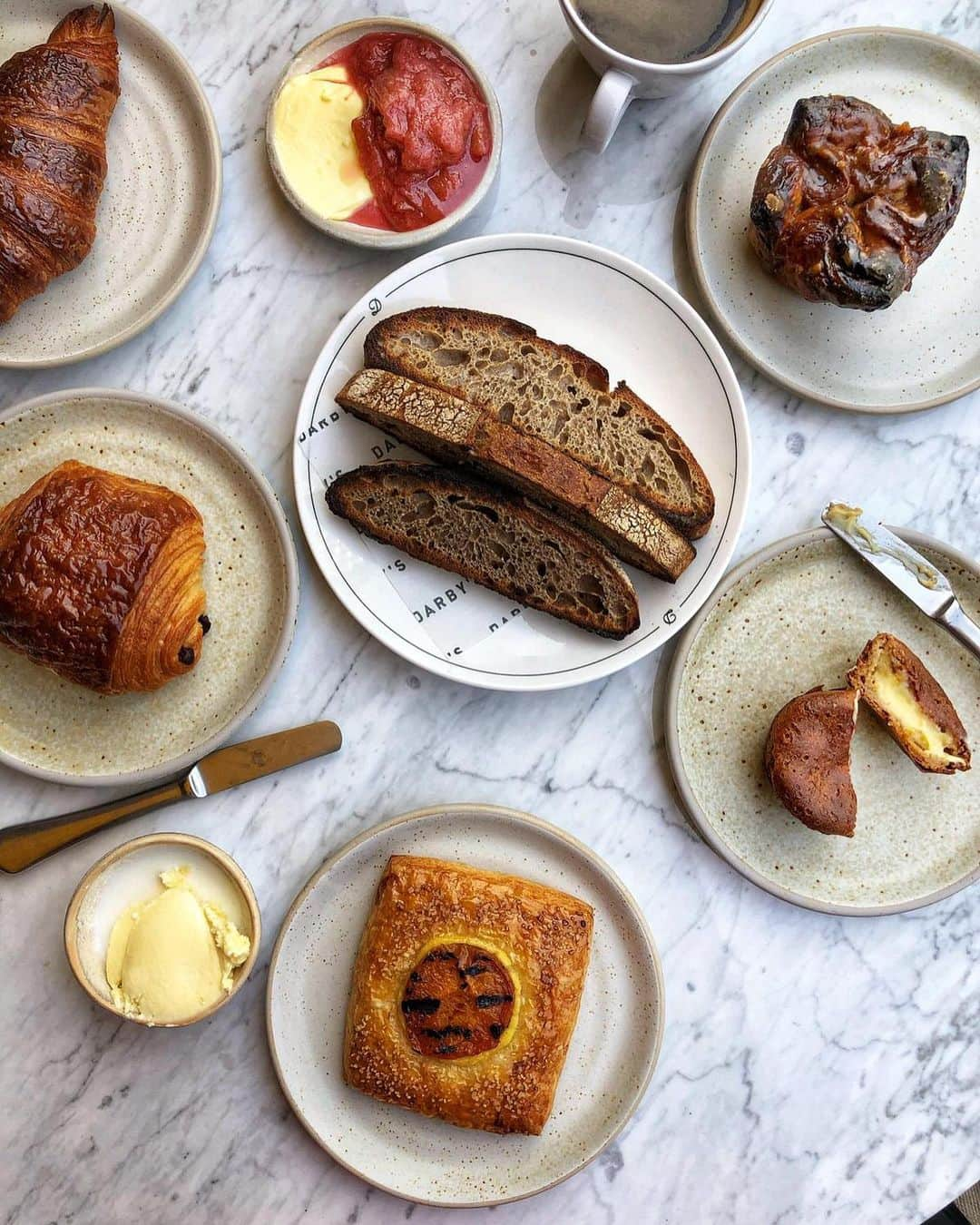 @LONDON | TAG #THISISLONDONさんのインスタグラム写真 - (@LONDON | TAG #THISISLONDONInstagram)「Morning! It’s @felicityspector here tucking into all the pastries at the brilliant new @darbyslondon opposite the US embassy in #Vauxhall... we’ve got a flaky deeply golden croissant, a Pump Street pain au chocolat, an apricot Danish, a coffee miso glazed kouign amann, plus a brilliant burnt honey muffin stuffed with a surprise tonka custard - and loads of sourdough toast with rhubarb jam and clotted cream. Plus head chef @deanoparker has even fired up the waffle iron to make us a sourdough waffle with creme fraiche and maple syrup which is coming to the breakfast menu soon! 🙏🏼😱 This latest restaurant from chef #RobinGill is truly superb - with an onsite bakery producing all kinds of breads and pastries... the savoury options look brilliant too! 👌🏼 Grab a table outside and enjoy the sunny terrace - and get these fabulous pastries while they’re hot! 🔥 // #thisislondon #londonfood #londonreviewed」5月24日 18時53分 - london