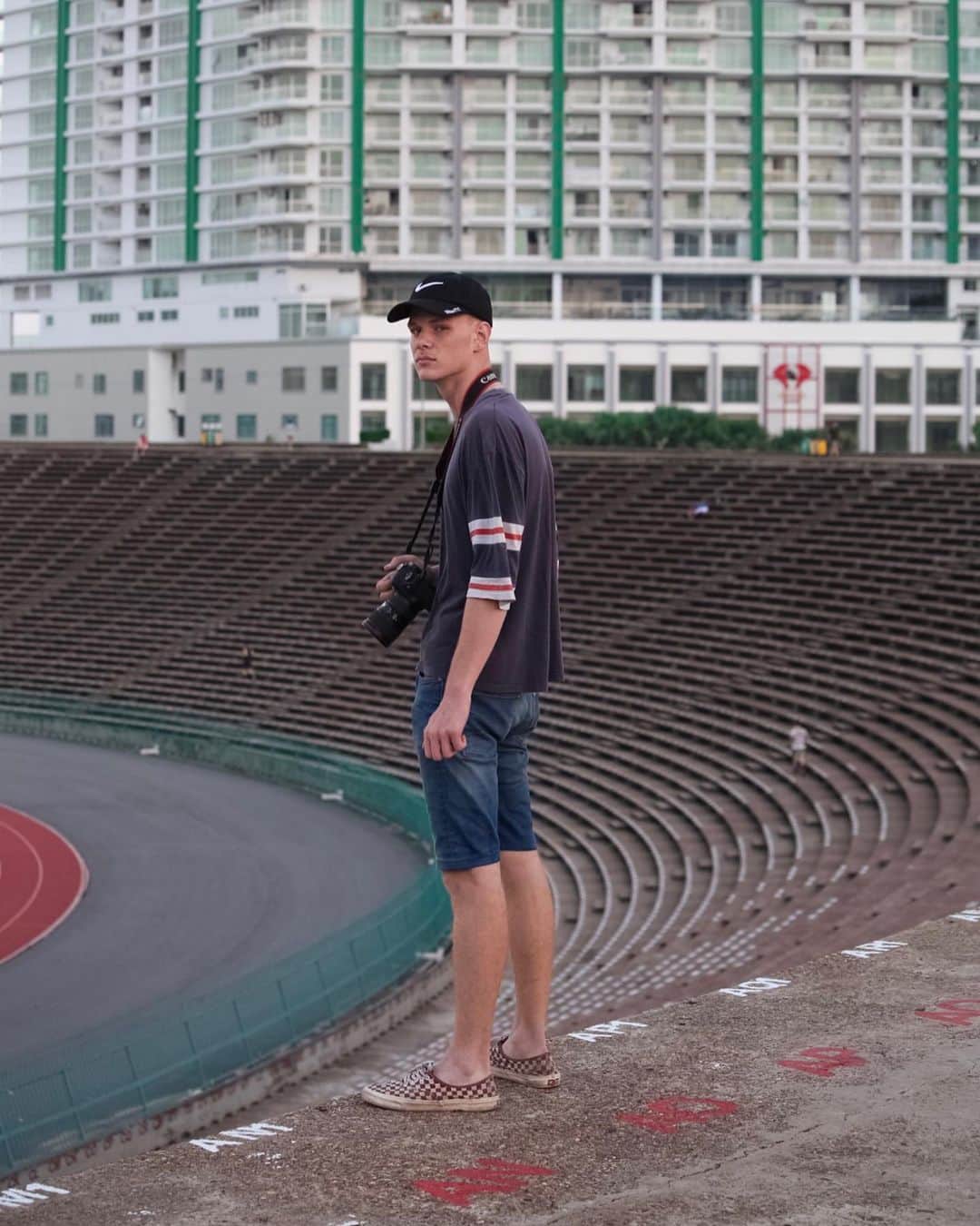 Shunsuke Miyatakeのインスタグラム：「A portrait of @bjoernteufel , a young passionate photographer from Germany. We met each other in 2017 and have been taking photos on the street of Phnom Penh. He is still super young but he doesn't care about my age. He's super active but all the things seem never enough for him. I took him at the Olympic Stadium at 0530am with hunger for his curiosity on his face.  Stay hungry, my friend.」