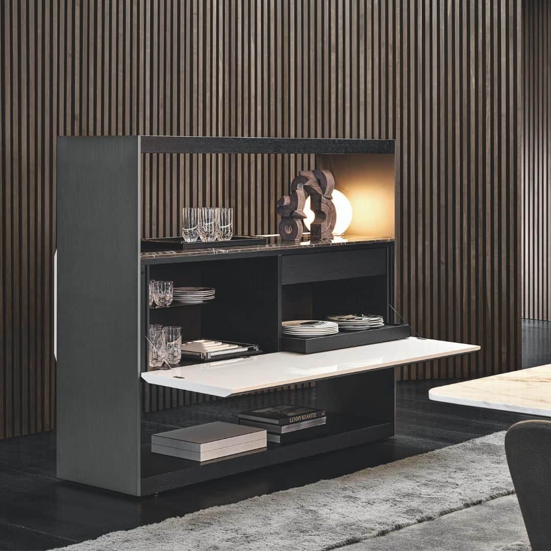 Minotti Londonさんのインスタグラム写真 - (Minotti LondonInstagram)「The Carson family welcomes the buffet version of the bookcase, characteristically inspired by a simple, contemporary look with clean lines that mark out the frame and central volume.  The striking effect created by combining different thicknesses makes a comeback, with thinner ones for the sides in satin finish aluminium, painted Malt colour, and thicker ones for the bottom shelf and the highest top in Moka-coloured ash.  The central "buffet" volume looks suspended and features a top in Stone Grey marble. The top presents an elegant faceting that joins up with the same distinctive faceted detail on the edge along the length of the long doors, created with a painted finish in the shades of Warm Grey or Moka, or in Moka-coloured ash.  Inside, it conceals a free compartment for storing dishes and glasses and an equipped area with a sliding tray on runners to make the objects inside easier to pick up. A drawer reveals the sophisticated cutlery holder in saddle hide.  The interesting contrast between full and empty volumes in Carson Dine is complemented by the unique textures and colours of the materials, in a succession of alternate painted, metallic and wooden surfaces.  #luxury #designinspiration #interiordesign #interiors #minottilondon #london #interior #beautiful #beautifulhomes #home #furniture」5月26日 18時30分 - minottilondon