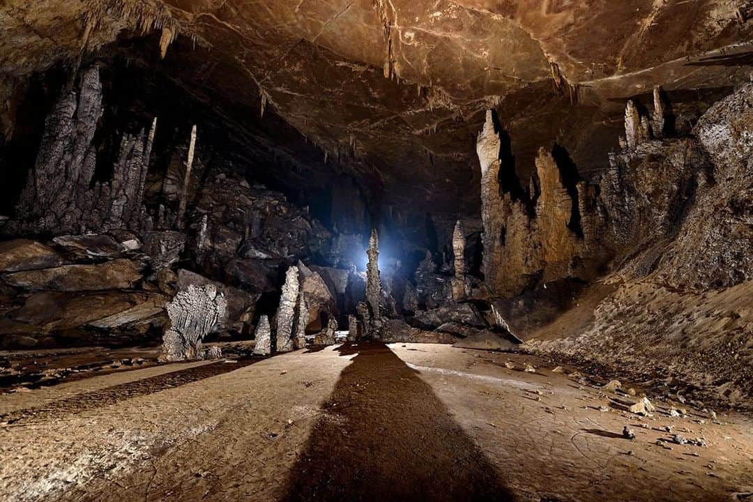 National Geographic Travelさんのインスタグラム写真 - (National Geographic TravelInstagram)「Photo by Robbie Shone @shonephoto | Tall, majestic, and beautifully formed stalagmites overlook a level playing field of sediment and dry sand. Blown away by wind, the floor of this room has cracked over time. San Wang Dong in China's Wulong County has many ancient secrets that await illumination.」5月10日 10時09分 - natgeotravel