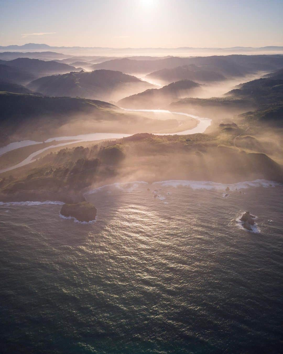 National Geographic Travelさんのインスタグラム写真 - (National Geographic TravelInstagram)「Photo by @andy_bardon // Sponsored by @OnePlus // The Russian River, also known as Bidapte ("big river") by the native Pomo, weaves its way through the Northern California countryside for 110 miles before reaching the Pacific Ocean. I had visited this biodiverse ecosystem before and knew that an aerial perspective would be dramatic, so I did my best to line up a sunrise flight. After making a number of calls, a friend introduced me to a pilot who took us up in his 1948 Cessna 170. Twenty minutes later we found ourselves at the mouth of the Russian River with just enough fog rolling through to create a bit of drama in the photograph. // Inspired by Nature presents the beauty of our natural world through the eyes of three leading National Geographic photographers and the lens of the new OnePlus 7 Pro. #ShotonOnePlus.」5月10日 2時56分 - natgeotravel